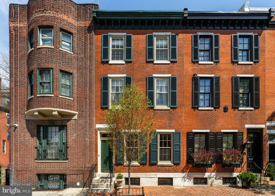 Welcome to 2131 Delancey Place in Rittenhouse Square. Spanning 2900 square feet over four levels of living, this 18ft wide home features high ceilings, perfectly polished finishes, and natural light that pours in from its south-facing windows. Enter through the vestibule into an elegant living room with custom built-ins flanking the fireplace, hardwood floors, an enclosed dry bar, and a large opening welcoming you into the kitchen and dining area. The recently renovated kitchen offers marble counters & backsplash, custom cabinetry, a SubZero refrigerator, a Wolf gas cooktop, wall oven & built-in microwave with convection. Glass sliders lead to a charming brick patio - perfect for grilling & gardening. This level is complete with a powder room and coat closet. Up the stairs to the second level is the south-facing primary bedroom featuring a spacious en-suite bathroom with a double-vanity marble sink, soaking tub, glass-enclosed shower, and custom built-ins with storage. Adjacent to the primary suite is a den/fourth bedroom with a bay window, custom built-ins, and an en-suite bathroom with a single vanity sink and bathtub/shower combo. Two additional bedrooms with a Jack-and-Jill bathroom are located on the third floor. The finished lower level includes a rec room, laundry & storage. Additional features include a heated sidewalk (snow melt system), 2 zones of HVAC, and upgraded systems throughout. This classic Philadelphia townhome sits directly between the hustle & bustle of lively Rittenhouse Square and the locally owned shops, restaurants/cafes, and green spaces of Fitler Square - allowing for easy access to the best of both. Additionally, this location is a short commute to Penn, CHOP & 30th Street Station. It is located in the Greenfield School catchment.
