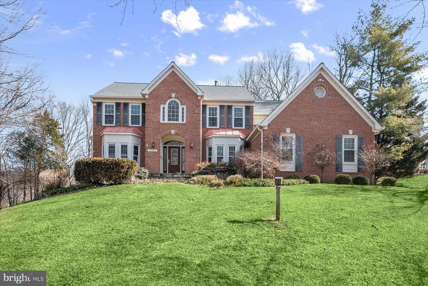 OPEN SUNDAY, 2-4 PM! Welcome to 12200 Canterfield Terrace! This grand center-stair colonial offers timeless elegance, impressive scale, and thoughtful updates throughout, all set on a quiet and expansive lot in a highly desirable setting. A dramatic two-story foyer makes a striking first impression, complemented by rich hardwood floors and a classic, well-balanced layout designed for both everyday living and sophisticated entertaining. The formal living room is filled with natural light from two beautiful bay windows and flows seamlessly to a tucked-away private home office through French doors, creating the perfect blend of openness and privacy. The formal dining room, also accented by a bay window and architectural detailing, provides an inviting and refined space for hosting gatherings both large and small.

At the heart of the home, the renovated open-concept kitchen is designed to impress, featuring a generous center island, abundant cabinetry, and a spacious eat-in area enhanced by skylights. Sunlight pours into this space, while direct access to the expansive deck creates a seamless indoor-outdoor lifestyle ideal for entertaining or relaxed everyday living. Just off the kitchen, the sunken family room offers a warm yet dramatic setting, complete with a striking stone mantel, gas fireplace, recessed lighting, and a well-appointed wet bar that elevates the space for entertaining. A beautifully appointed powder room, along with a convenient main-level laundry room and pantry, complete the main level with both style and function.
Upstairs, the expansive primary suite serves as a true retreat, featuring vaulted ceilings, abundant natural light, and two spacious walk-in closets. The en-suite bathroom is thoughtfully designed with dual vanities, an oversized soaking tub, and a separate walk-in shower, offering a spa-like experience at home. Three additional generously sized bedrooms provide flexible living options, including one oversized bedroom with dual closets and custom shelving. The recently renovated hall bathroom is both stylish and functional, featuring dual vanities and a tub with a tiled shower and glass enclosure, along with a conveniently located linen closet.

The fully finished walkout lower level, renovated and expanded in 2017, is an exceptional extension of the home’s living and entertaining space. This level features a sprawling recreation room with durable LVP flooring, a dramatic stone accent wall, a full bathroom, and multiple storage areas, including a large dedicated storage room. With direct access to the backyard, this level offers incredible versatility for entertaining, relaxing, or accommodating guests.

The oversized two-car garage is equally impressive, offering insulated doors, overhead storage, and a temperature-controlled bonus space with built-in storage - perfect for a home gym, workshop, or flexible use space. Outdoors, the home truly shines with its large, private lot and expansive deck, providing an ideal setting for outdoor dining, entertaining, or simply enjoying the peaceful surroundings. Additional highlights include newer windows, HVAC, and a brand-new dishwasher, offering peace of mind for years to come. Ideally located near parks, trails, shopping, dining, and major commuter routes, this exceptional home combines classic architecture, modern updates, and an unbeatable setting.

Square footage is based on tax records and third-party information; please independently verify.
