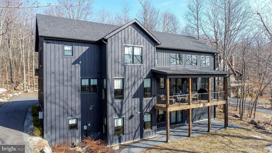 Sleek. Spacious. Stunning. "No Black Tie Affair" is more than a house—it’s an experience. Over 5,400 sq ft of modern luxury tucked into Deep Creek Highlands, with access to a lakeside park, hiking trails, outdoor pool, and more. Abundant natural light floods the open-concept design, highlighting quartz counters, a walk-in pantry, and a gas fireplace that anchors the main living space. Five bedrooms, each with its own elegant ensuite, plus two half baths for convenience. Loft overlooking the great room, adding another layer of space. Downstairs, the walk-out basement delivers a second living area, pool table, wet bar, and a partially finished game area—air hockey included! Step onto the Trex deck for panoramic mountain views, soak in the hot tub, or gather around the private firepit under a sky full of stars. Built in 2021, and already a well-established rental. Set on over half an acre of wooded land, this is the kind of place that turns weekends into lifelong memories. No dress code required... Call today for details!