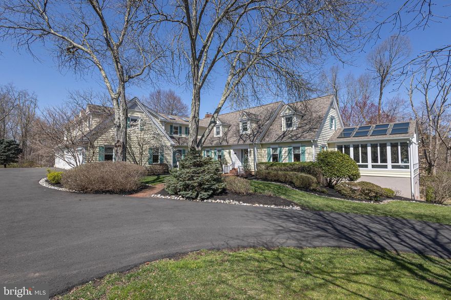 A charming, expanded Cape Cod nestled on just over 3 acres of meticulously landscaped grounds just minutes from historic Washington Crossing State Park. This residence seamlessly blends elegance, comfort and oneness of nature. From custom millwork and wide-planked oak floors to the expansive, light-filled sunroom; every detail has been thoughtfully designed and executed. The heart of the home is a spacious kitchen that flows into a spacious family room with a wood-burning fireplace. Entertaining effortlessly with a home theater and walkout lower level with full custom-built 3-tap 12-seat bar complete with a temperature-controlled wine cellar, game room, office, workout room and whatever else you can imagine. Upstairs you will find 4 bedrooms each with ensuite bath offering ample space for family and guests including a bonus private au pair/guest suite on the main level. The primary suite is a true sanctuary, featuring a cozy fireplace, private deck, and spacious bath. Beyond the interior, discover outdoor living at its finest: multiple decks, a paver patio, and a fire pit overlooking the lush landscape and serene creek. A temperature-controlled 7-car garage and a lawn irrigation system complement the outdoor space. We invite you to experience this exceptional property. Schedule your private tour today.