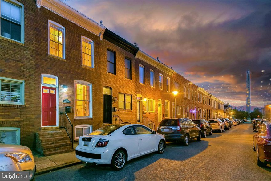 Live snuggled beneath the twinkling lights of desirable S. Glover Street in the heart of Canton! Large, open floorplan with 3 bedrooms, 2 bathrooms, two-tiered roof top deck, fully fenced rear patio with potential for parking, finished basement, hardwood floors, recessed lights, modern hand welded black steel banister and surround sound throughout the house. Enter into the  home to find a charming dining room with exposed brick accent walls, hardwood floors and enough space for a large dining table and bar. The updated kitchen with granite counters and stainless steel appliances is conveniently anchored between the living and dining rooms, making entertaining effortless. The living room offers plenty of space to set up  a great home theatre or relaxing lounging space- with surround sound speakers and beautiful divided light pocket doors you can close it off for more privacy or keep the space open to the rest of the house. From the living room, high end Pella sliding glass doors invite you onto the fully fenced rear patio where there is plenty of room for a grill and outdoor seating OR removed the existing wall to add parking. Upstairs find 2 large bedrooms with ample light and 2 renovated bathrooms one with a tub-shower combo and the other with a standing shower. The basement is fully finished with high ceilings and a large window making it perfect for a family room, gym, home office or could be used as a 3rd bedroom. Enjoy warm summer nights while watching fireworks, air shows or hosting parties on the fabulous multi level rooftop deck where there are sweeping views of the city skyline from every vantage point. Take advantage of the incredible Canton location- walk the historic streets, dine, shop, or stroll along the Canton waterfront. Hop on the water taxi and explore other parts of the city with ease or head to Patterson Park where there are walking paths, playgrounds, a dog park, community pool, ice skating rink, sports courts and a lake. Enjoy excellent proximity to I95, Downtown Baltimore and Johns Hopkins Hospital.