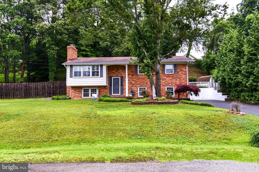 PRIVATE WATER COMMUNITY! 5 BEDROOM 2.5 FULL BATH BRICK HOME SITS ON .42 ACRE LOT IN SOUGHT AFTER HILLSMERE ESTATES! FRESHLY PAINTED THROUGHOUT! UPPER LEVEL HARDWOOD FLOORS HAVE BEEN REFINISHED! UPDATED KITCHEN W/ SS APPLIANCES, QUARTZ COUNTER TOPS, TILED BACKSPLASH, TABLE SPACE W/ BREAKFAST BAR & RECESSED LIGHTING. LIVING ROOM HAS BRICK FIREPLACE AND MANTEL, HARDWOOD FLOORS, BAY WINDOW W/ PLANTATION SHUTTERS.  DINING ROOM & BONUS SUNROOM IS SURROUNDED BY WINDOWS W/ PLANTATION SHUTTERS & 2 SETS OF FRENCH DOORS W/ ACCESS TO SIDE DECK AND EXT REAR PATIO.  PRIMARY EN-SUITE HAS LIGHTED CEILING FAN,  PRIVATE POWDER ROOM AND SLIDER DOOR W/ ACCESS TO REAR PATIO.  2 ADDITIONAL SPACIOUS BEDROOMS W/ HARDWOOD FLOORS. BEDROOM 3 HAS IN CLOSET AN ALL IN ONE WASHER/DRYER COMBO.  THIS CAN BE REMOVED, BUT GIVES BUYER OPTION TO HAVE A RENTAL ON EACH LEVEL.  HALLWAY BATHROOM W/ UPDATED TILED TUB SHOWER AND FLOORS.  LOWER LEVEL HAS ADDITIONAL KITCHEN W/ TOASTER OVEN, MICROWAVE, SS REFRIGERATOR, MOVABLE ISLAND W/ CABINETS AND COUNTER TOP BURNERS.  FAMILY ROOM HAS  BRICK FIREPLACE AND MANTEL. TABLE SPACE . FULL BATHROOM W/ TUB SHOWER.  2 ADDITIONAL BEDROOMS AND LAUNDRY ROOM W/ BUILT IN CLOSET AND SHELVES.  EXT SHED AND FENCED IN REAR YARD.  FLAT ROOF 2025 AND EXT CHIMNEY REFINISHED. SWIMMING POOL AND SOCCER FIELD DIRECTLY ACROSS THE STREET.  THIS COMMUNITY HAS AN OPTIONAL IMPROVEMENT ASSOCIATION  FOR $25/YEAR BUT NOT REQUIRED.  HILLSMERE COMMUNITY HAS LOTS OF AMMENITIES!