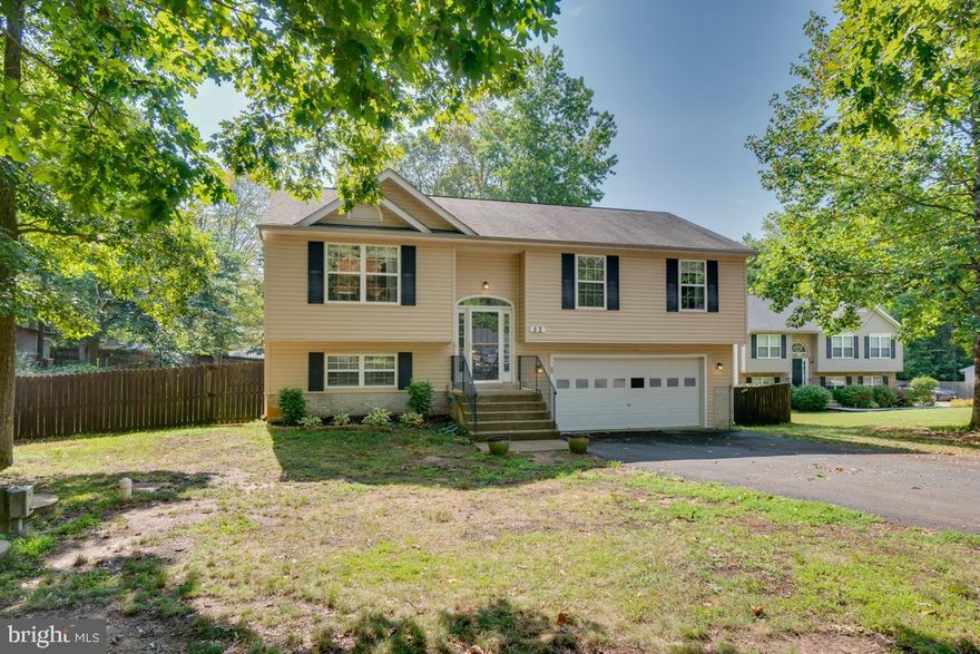 Wonderful 4 bedroom, 3 bath home in Lake Community!  This home is located off of 610 in Stafford, close to commuting routes, back gate of Quantico, schools and shopping!!  The main level of the home boasts VAULTED CEILINGS and easy care laminate floors.  The kitchen is bright and open, with white cabinets and gleaming appliances that are less than 3 YEARS OLD!   Dining area is open to both the kitchen and family room and has doors leading directly out to the upper deck!  The master bedroom has an attached bath and TWO CLOSETS!  On the lower level you will find the laundry room, office/REC room and a fourth bedroom (with closet and attached full bath) that opens to the lower level deck! The spacious yard is inviting for all backyard activities.  Completing this home is an attached TWO CAR GARAGE!  Bring your fishing poles, canoes and paddle boards to enjoy lake living with NO HOA!