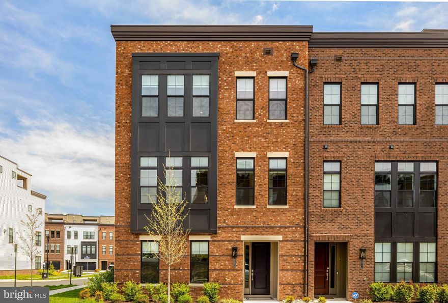 EXCITING NEW OFFERING - OPEN FRIDAY, 4/17 FROM 5:30PM TO 7:30PM AND SUNDAY, 4/19 FROM 2-4PM. 

Discover the perfect blend of sophisticated elegance and effortless living in this stunning 2024 Toll Brothers end-unit townhome in Ashburn’s sought-after Metro Walk community.

This NoMa Virginian model spans four beautifully finished levels and features rich 6½-inch engineered white oak hardwood floors, elegant two-tone paint, recessed and designer lighting, and custom window treatments throughout.

The welcoming entry level features a spacious flex room with a full bath—ideal as a home office or fourth bedroom—plus two closets and direct access to an extra-wide garage. The open-concept main level boasts a gourmet kitchen with a large center island, sleek cabinetry, quartz countertops, and a walk-in pantry, which opens to a living area with a gas fireplace, formal dining space, a powder room, and a large covered balcony.

On the bedroom level, the primary suite features a generous walk-in closet and a spa-like bath with a freestanding tub, an oversized glass shower with a seat, a dual-sink vanity, and a private water closet. Two additional bedrooms share a full hall bath, and a convenient central laundry room is nearby.

The finished fourth-floor loft features a wet bar, beverage cooler, powder room, and multi-panel doors that open to a rooftop terrace with both covered and uncovered seating—ideal for relaxing or entertaining.

Just steps from the clubhouse, pool, gym, and yoga studio, and an easy walk to the Ashburn Metro Station, this low-maintenance home offers modern luxury in one of the area’s most convenient locations.