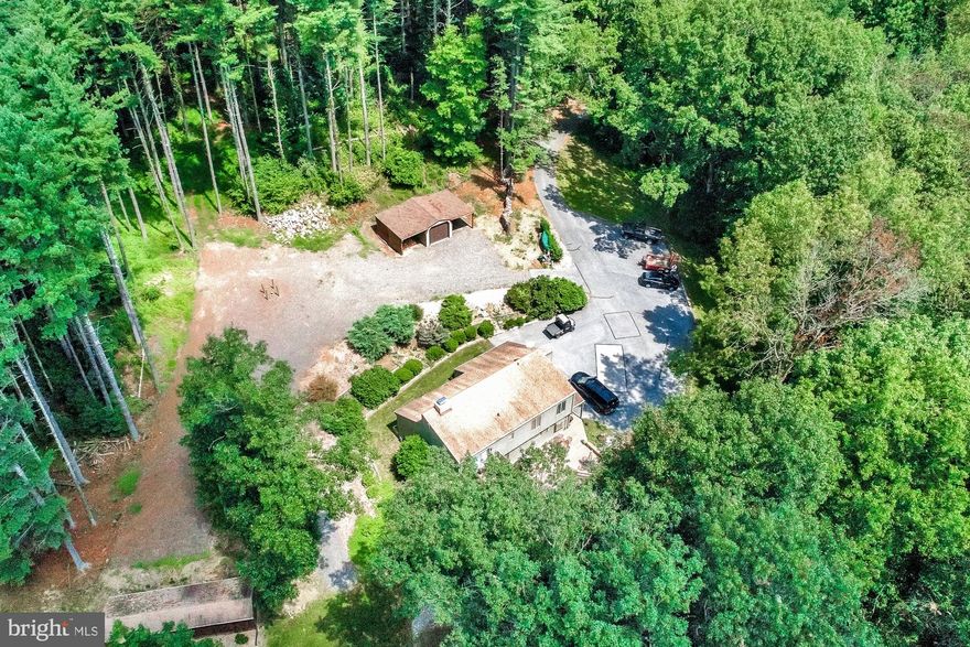 This 26+ acre property has privacy at it's best.  The house sits back a long gated blacktop driveway practically in the middle of the 26 acres.  Mature trees, stream, and tons of room for recreation, hunting, or whatever else you enjoy.  The 3 BR / 2 1/2 bath contemporary home is in great condition with hardwood and tile floors, plus a wood burning fireplace and wood stove for additional heat source.  Just bring your recreation ideas and equipment and enjoy!!  The property is within walking distance of Prettyboy Dam!!