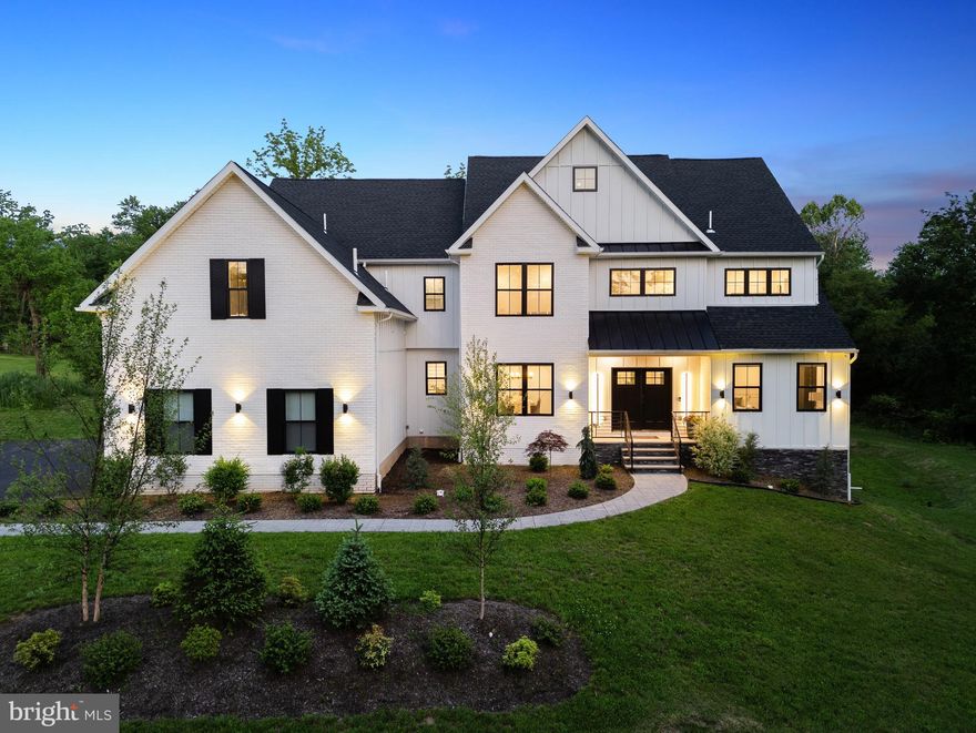 Redefining the landscape of luxury new construction, TENNIS POINTE emerges as a singular collection of four architecturally curated residences, each a testament to timeless design and uncompromising quality. Conceived in collaboration with esteemed architect Morrissey, these homes embody a harmonious blend of Modern Colonial elegance & refined Farmhouse. Every residence has been meticulously crafted with expansive layouts, & richly appointed interiors. Undeniably extraordinary upon first glance 962 Tennis sits atop a raised elevation is this stunning residence clad in a white façade with black accents.  Make your way up the pedestrian path leading to the limestone porch. Through the double doors enter the towering foyer. Notice the floors fitted with Long Leaf Acacia hardwood surrounding the stunning central staircase. On your right is the living room with an ample array of windows offering natural lighting, intricate trim work and most notably a beautiful gas fireplace, laden in floor-to-ceiling marble.  Across the foyer sits the formal dining room, an accent wall brings contrast to the space.  You will find a butler's pantry as you make your way into the kitchen.  The first of three main focal points of the home, the gourmet kitchen is truly remarkable with its oversized island and 42" Aster Cucine custom cabinets fitted with quartz countertops, Bertazzoni stainless steel appliances, including a pro series 6-burner gas oven/range and hood and pendant lighting.  Fitted in beautiful tile you can find a mud room, leading to the side-entry door, a bonus room and access to the 3-car garage.  Extending past the breakfast area is the great room, featuring a 2-story ceiling, tons of windows.  Look back at the kitchen and notice the waterfall edge imbuing the homogenous space. The remainder of the main level holds a well appointed powder room and a first floor visitor suite with its own closet and private bathroom, featuring a frameless glass shower stall and clad in majestic large format tile. Up the stairs to find an open to below loft area which bridges the bedrooms on the  second level.  Two bedrooms are adjoined with a jack and jill bathroom, featuring a custom floating vanity, hex tile floors and an extra deep tub/shower; all fitted with satin brass bathroom fixtures.  Next you will find the laundry room with a built-in linen closet, sink and quartz countertop acting as a folding station.  Across the hall is another bedroom with a large walk-in closet and en-suite bath.  Through the French doors lies the primary bedroom. This second focal point of the home sets itself apart with its chandelier descending from the tall cathedral ceiling.  A shiplap laden wall offers a nice touch.  Making way toward the primary bath, you stumble upon two walk-in closets, fitted with custom organizer systems.  No primary suite is complete without a true spa-like bathroom.  Marble mosaic tile with golden inlays adorns the room. Also catching the eye is a massive double vanity with make-up table, free standing tub, walk-in shower with custom glass, diverter manipulating the rain, wall and handle head shower heads and a private water closet. The entertainment driven lower level stands as the third main focal point, featuring a media room, game room, fitness area, and a full bar with quartz counters. Yet another full bathroom presents itself in the lower level.  A walkout stairs leads out to the backyard.  Sitting on 1.25 acres,  the property holds a superb backyard, backing up to a wooded area.  A large interlocking stone patio sits off of the kitchen ideal for hosting summer events.  Given its grand scale, the home has too many features to name, but a few notable ones include high efficiency dual zone heating and cooling with NEST thermostat controls, Andersen windows, Therma-Tru exterior doors, exterior landscape package, satin brass fixtures, square trim LED recessed lighting and much more. Schedule an appointment to tour this masterpiece today!