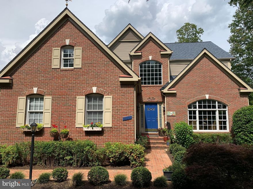 MUST SEE!  Stunning 6 level home with over 5600 sq ft of living space tucked away from the hustle and bustle and surrounded by Mother Nature.  
The circular foyer welcomes you into this home and instantly tells you that you’re someplace special. This
is a builder’s home, with many extras and upgrades. The 20-foot ceiling with custom chandelier makes
an entrance to be proud of.  Main level features natural oak hardwood flooring throughout, an elegant parlor with stately crown molding, a large formal dining room adorned with wainscoting, and a spectacular eat-in, gourmet kitchen.
The 28'x13.5’ kitchen was renovated in 2019 with stainless steel appliances, gorgeous quartz
countertops, glass tile backsplash, a large custom-built island with seating for 4 or more, a walk-in
pantry, a multitude of cabinets with soft-glide closure, customized drawers for organized storage,
under-cabinet lighting and outlets, and room for a large table and chairs. With specially
commissioned paintings adorning the walls, you feel transported to exotic places as part of your
culinary experience.
The kitchen also has access to the screened in-porch with vaulted wood ceiling, a wonderful spot for
al fresco dining and access to the enclosed side yard. There is also a ½ bath on the main level.
Heading up to the second level, you will find three nice sized bedrooms; one with ensuite bath; one shared jack-n-jill bath, all with beautiful windows that bring in the light. Newly installed black-out shades allow for great sleep.
Above the second level, you will find an entire floor is dedicated to the Main Bedroom Suite with a 20'x18'
bedroom featuring crown moldings, his-and-her walk-in closets, a large bathroom with separate sinks
and counters, a large soaking tub, tiled shower with seating, and a plethora of cabinets and drawers.

Heading down from the main level, you will come to the 26'x16’ formal living room which includes a gas fireplace, crown molding, and sliding door access to the upper deck. A full bath and spacious office complete this level of the home. The office has large closets and could also be used as a 6 th bedroom.

7 steps down from this level, you’ll find Entertainment Central where you can invite guests for dinner, drinks, dancing and a movie! This level features a beautiful full bar (upper & lower
cabinets, glass backsplash, under counter storage, wine fridge, half fridge, ice maker, microwave, 2-
drawer dishwasher, stainless sink, and 5 stools), a dance floor, and a theater room with projection onto a
122-inch diagonal screen. This level also has a spacious storage closet, and a gift-wrapping room.
The bottom level of the house includes a large family room, ½ bath, and a full bedroom. Walk out
onto the spacious lower deck that is perfect for entertaining outdoors with room for a large seating
area, large outdoor dining table, and grill. Overlooking pretty Pohick Creek, being on the back deck is
like being in a tree house. Views are terrific with great vantage points for bird and wildlife watchers.
Stairs down to a large platform allow access to the water. Terrific walking trails on the Cross-County
Trail System allow you to get out and enjoy the area by foot or bike. Trees abound at this property. A beautiful Japanese maple anchors the front walkway. Mature Leyland cypress trees
along the entire front provide beauty and privacy. There is also a fenced-in side yard, great for family pets.  
Fantastic oversized 2 car garage accommodates cars, workbench, bikes, and storage. Pull-down stairs
for easy access to the attic space with additional storage.  Also, don't forget to visit the multi level garden near garage.
Feeds to Newington Forest Elementary and South County High School.  
Just minutes to to 1-95, Ft Belvoir, VRE Lorton Station, COSTCO, and tons of other shops/restaurants. Roof just 4 years old! 2 HVACs. BOOK YOUR APPOINTMENT TODAY!  THIS IS A CROWN JEWEL NOT TO BE MISSED! Sellers request rent-back through Aug. 31st.