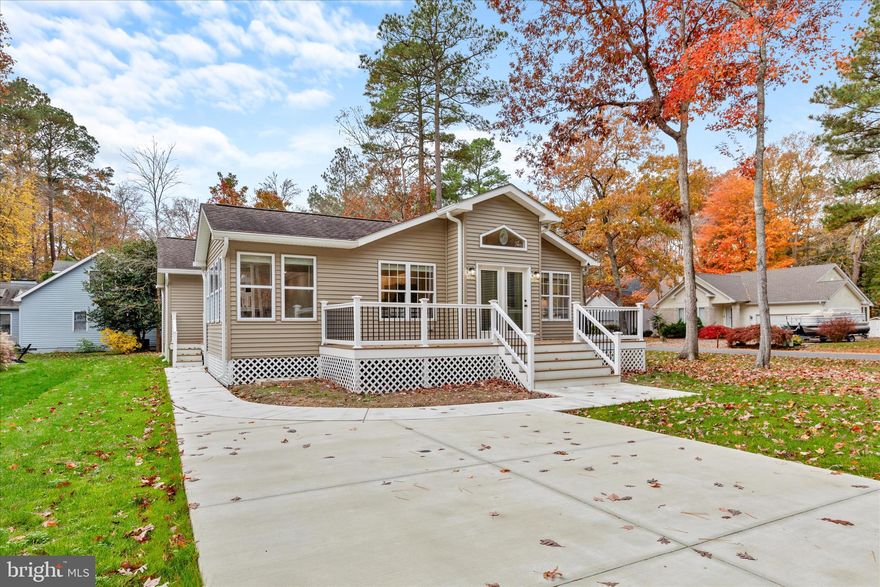 Welcome to your new beach house in the sought-after community of Ocean Pines, a beautifully updated and meticulously maintained retreat that captures the essence of easy, uplifting coastal living.

Step through the double atrium doors into a bright, airy foyer with vaulted ceilings and a large transom window that fills the space with natural light. The abundance of windows throughout gives every room a cheerful, sun-kissed feel, while the all-new paint and modern window shades create a fresh, cohesive style.

Luxury vinyl plank flooring flows seamlessly throughout the home, complementing the open design. The family room is warm and welcoming, featuring vaulted ceilings, recessed lighting, and a gas fireplace with a new gas valve and ignitor. A newly installed shiplap accent wall adds just the right coastal touch, tying the room together beautifully.

The kitchen and dining area continue the bright coastal palette with white cabinetry, black hardware, and quartz countertops accented by a glass tile backsplash. A new beverage cooler, new countertops, and stainless steel appliances make entertaining a breeze, while gas cooking and a new washer and dryer add convenience.

Every detail has been thoughtfully updated, from the all-new baseboards, ceiling fans, smoke detectors, electrical outlets, switches, and plates to the new closet organizer racks that make storage simple and stylish. Both bathrooms have been completely remodeled, each with skylights that bring in soft, natural light, modern finishes, and a clean, spa-like feel.

Outside, the home is just as impressive. The exterior has new siding on the front and side, new gutters with six-inch downspouts, and the entire home was recently power washed for a spotless finish. A brand-new TimberTech deck with a PVC railing system extends your living space outdoors, perfect for morning coffee or summer gatherings. The new concrete driveway and sidewalk provide plenty of parking, wide enough for a boat, wave runners, or guests. The yard features new grass with a one-year prepaid lawn service, and even the surrounding trees have been professionally removed to open up the landscape. A new hot water heater ensures comfort and efficiency for years to come.

Living in Ocean Pines means you can enjoy a peaceful setting surrounded by nature, plus year-round access to outstanding amenities including a marina, swimming pools, sport courts, playgrounds, walking trails, a seasonal farmers market, and the Ocean Pines Beach Club in Ocean City for easy seaside access.

This home truly offers coastal living made easy, fully updated, beautifully refreshed, and ready for you to simply move in and start enjoying the relaxed, fun, and refreshing Ocean Pines lifestyle.