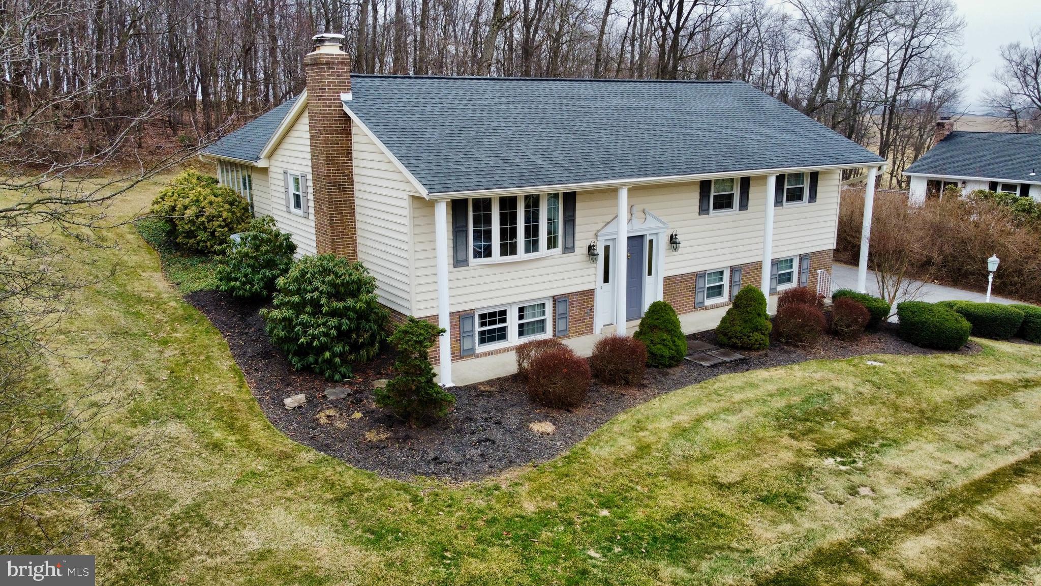 Heartwarming Residence! Experience this exceptional home located on a cul-de-sac near Lion's Park. The sunroom, measuring 14'1 x 19'8, features vaulted ceilings, skylights, a ceramic tile floor, and French doors that provide access to the living room or the covered brick porch. The expansive country kitchen is equipped with a rolling island, ideal for serving guests, along with generous cabinetry and a designated desk area. A built-in shelf for the microwave and ceramic tile flooring enhance the kitchen's functionality. The owner's suite includes an adjoining bathroom for added convenience. Two Additional Bedrooms w/ carpet and window treatments. The lower-level family room is highlighted by a wood-burning brick fireplace, and there is a small room that was previously used as an office. Laundry facilities are conveniently located in the utility room. In 2018, a new 50-year architectural roof was installed, along with new gutters featuring leaf guards. Additionally, a 24 x 12 wood deck was constructed in 2022, extending from the brick-covered rear porch. The property also boasts an oversized two-car garage measuring 26 x 21. ***See the walking Video of the property at the icon above the picture***