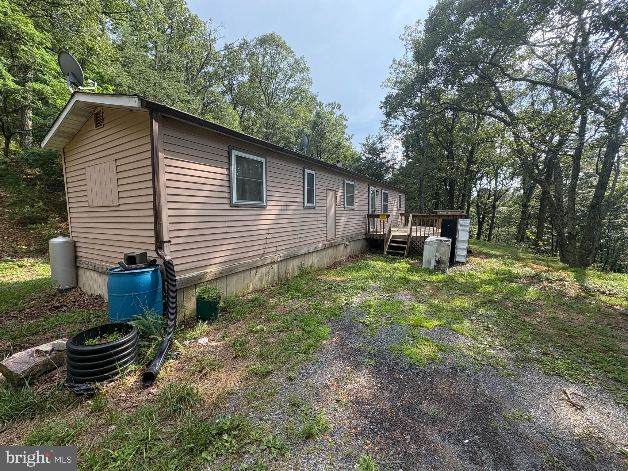 This property offers an excellent opportunity for a weekend getaway or year-round living. It features a 1-bedroom, 1-bathroom 12x60 mobile home situated on 18+ acres, ensuring complete privacy and seclusion. The home boasts a large front deck, perfect for relaxing or entertaining guests. The surrounding land provides great hunting opportunities and is conveniently located near Lost River Resort and the National Forest. You'll also enjoy beautiful mountain views and good access to the property.
Additional features include a storage shed and ample level parking. From the house, no other properties are visible, adding to the private feel. The expansive property also offers numerous roads for 4-wheeling.
This is a unique opportunity, so act fast.