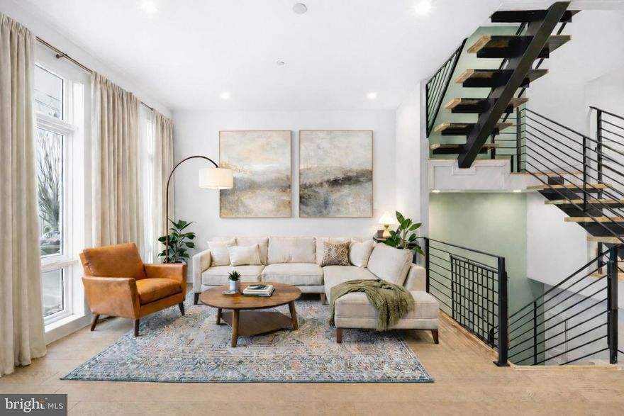 Welcome to 2512 E Cumberland Street — Fishtown Luxury Residence

Rare 20-foot-wide luxury home offering exceptional scale, refined finishes, private multi-car parking, and approximately 7 years remaining on the tax abatement.

Step inside to a grand, open living space with wide-plank hardwood floors and soaring sightlines through large open staircases that connect all levels, creating a dramatic sense of openness. The main living area flows seamlessly to the chef’s kitchen, set just two steps above for subtle separation, complete with high-end appliances, custom cabinetry, oversized island, pantry, and a first-floor coat closet. Patio doors open to a private balcony/deck — perfect for outdoor dining and entertaining.

The second floor features two generously sized bedrooms (one containing an ensuite) with huge walk-in closets, a full hall bath, a spacious and convenient laundry room with storage and a sink, and an additional living space for flexible arrangements for guests, family, or a home office.  The third floor is dedicated to a private primary suite retreat, complete with two walk-in closets and a skylight over the expanded landing, bathing the space in natural light.  A wet bar and additional half bath are convenient for hosting guests on the expansive roof deck.  With sweeping views of the Benjamin Franklin Bridge and Philadelphia skyline — this home offers an unforgettable cityscape backdrop for entertaining or relaxing. The fully finished lower level adds a full bedroom, full bathroom, extra storage, and a convenient drop-zone/mudroom with walk-out access to the two-car garage and additional 2 covered parking spaces.

This home combines scale, refined finishes, exceptional outdoor space, and rare multi-car parking in one of Philadelphia’s most vibrant neighborhoods.

Select photos have been virtually staged to illustrate potential furniture placement, color and room use.