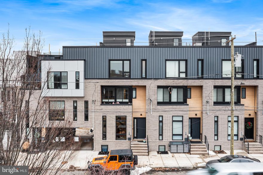 Welcome to 2512 E Cumberland Street — Fishtown Luxury Residence

Rare 20-foot-wide luxury home offering exceptional scale, refined finishes, private multi-car parking, and approximately 7 years remaining on the tax abatement.

Step inside to a grand, open living space with wide-plank hardwood floors and soaring sightlines through large open staircases that connect all levels, creating a dramatic sense of openness. The main living area flows seamlessly to the chef’s kitchen, set just two steps above for subtle separation, complete with high-end appliances, custom cabinetry, oversized island, pantry, and a first-floor coat closet. Patio doors open to a private balcony/deck — perfect for outdoor dining and entertaining.

The second floor features two generously sized bedrooms (one containing an ensuite) with huge walk-in closets, a full hall bath, a spacious and convenient laundry room with storage and a sink, and an additional living space for flexible arrangements for guests, family, or a home office.  The third floor is dedicated to a private primary suite retreat, complete with two walk-in closets and a skylight over the expanded landing, bathing the space in natural light.  A wet bar and additional half bath are convenient for hosting guests on the expansive roof deck.  With sweeping views of the Benjamin Franklin Bridge and Philadelphia skyline — this home offers an unforgettable cityscape backdrop for entertaining or relaxing. The fully finished lower level adds a full bedroom, full bathroom, extra storage, and a convenient drop-zone/mudroom with walk-out access to the two-car garage and additional 2 covered parking spaces.

This home combines scale, refined finishes, exceptional outdoor space, and rare multi-car parking in one of Philadelphia’s most vibrant neighborhoods.