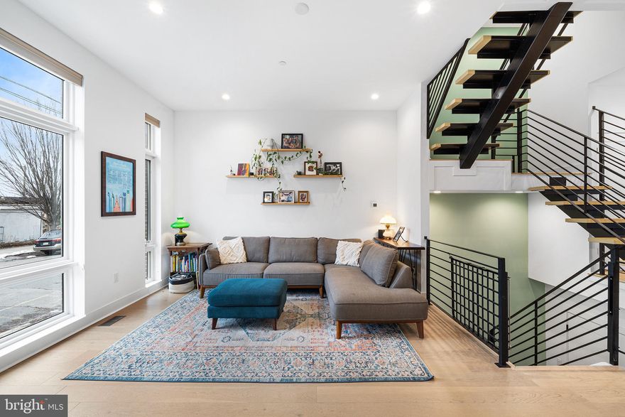 Welcome to 2512 E Cumberland Street — Fishtown Luxury Residence

Rare 20-foot-wide luxury home offering exceptional scale, refined finishes, private multi-car parking, and approximately 7 years remaining on the tax abatement.

Step inside to a grand, open living space with wide-plank hardwood floors and soaring sightlines through large open staircases that connect all levels, creating a dramatic sense of openness. The main living area flows seamlessly to the chef’s kitchen, set just two steps above for subtle separation, complete with high-end appliances, custom cabinetry, oversized island, pantry, and a first-floor coat closet. Patio doors open to a private balcony/deck — perfect for outdoor dining and entertaining.

The second floor features two generously sized bedrooms (one containing an ensuite) with huge walk-in closets, a full hall bath, a spacious and convenient laundry room with storage and a sink, and an additional living space for flexible arrangements for guests, family, or a home office.  The third floor is dedicated to a private primary suite retreat, complete with two walk-in closets and a skylight over the expanded landing, bathing the space in natural light.  A wet bar and additional half bath are convenient for hosting guests on the expansive roof deck.  With sweeping views of the Benjamin Franklin Bridge and Philadelphia skyline — this home offers an unforgettable cityscape backdrop for entertaining or relaxing. The fully finished lower level adds a full bedroom, full bathroom, extra storage, and a convenient drop-zone/mudroom with walk-out access to the two-car garage and additional 2 covered parking spaces.

This home combines scale, refined finishes, exceptional outdoor space, and rare multi-car parking in one of Philadelphia’s most vibrant neighborhoods.