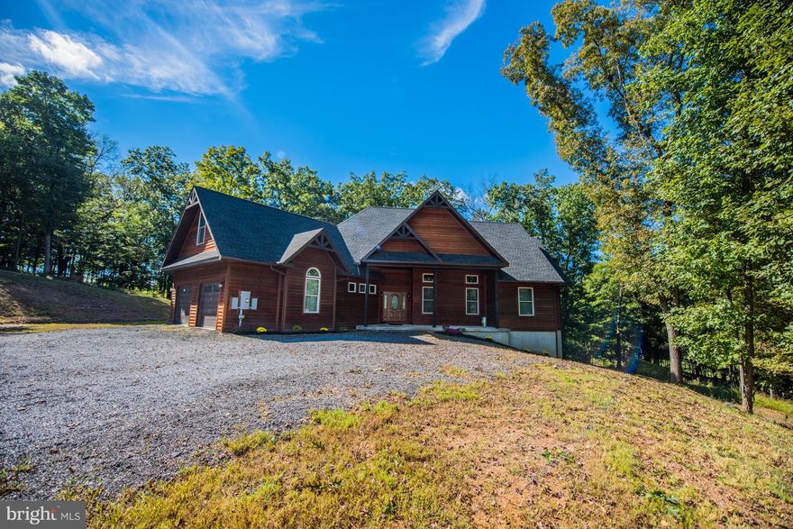 Custom blt 4BR/3.5BA cedar home nestled by trees & surrounded by pristine countryside. Featuring wood & ceramic floors, open floor plan w 12 tray ceilings, LR/DR/Kitchen w granite counter top & stainless steel appliances.  Master BR/BA w walk in closets & jetted tub for relaxing after a long day of work or play.  Front porch & wraparound deck for outdoor entertaining, 2 car garage+geo-thermal H/A