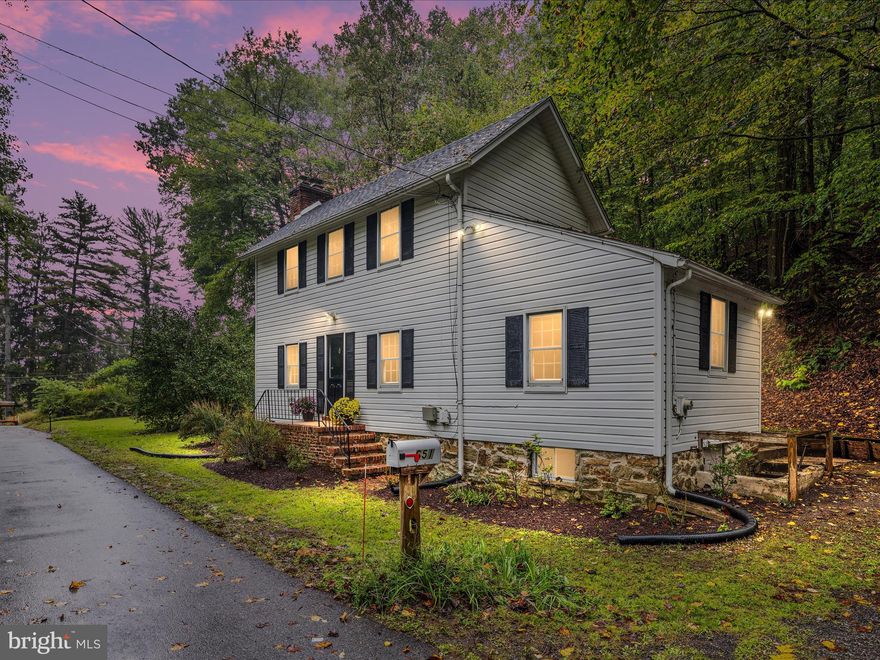 This classic farmhouse offers a rare combination of historic charm, natural beauty, and modern comfort in the heart of Green Spring Valley. Tucked away on a quiet road, the home provides a peaceful retreat surrounded by trees, a nearby stream, and the unique backdrop of a former quarry.
Inside, you’ll find 3 bedrooms and 2 full bathrooms, including a spacious main-level bedroom with an adjacent full bath for convenience. The inviting living room features hardwood floors with timeless character, and the home is equipped with central heating and air conditioning for year-round comfort.
Outdoor living is just as enjoyable, with a back patio perfect for relaxing or entertaining. A short walk leads you to a fire pit nestled under the dramatic quarry cliff. Across the road, a serene stream enhances the property’s natural setting.
The location offers the best of both worlds: a quiet, private setting with the convenience of nearby commuter routes. Access to I-83 and I-695 makes getting to downtown Baltimore, Towson, and surrounding areas simple, while still allowing you to come home to a retreat that feels far removed from it all. Just minutes down the road, you’ll also find small shops and local dining, that makes everyday living even more convenient.
Stevenson is also home to a number of highly regarded schools, including  Baltimore County Schools, as well as nearby independent options such as St. Timothy’s, Greenspring Montessori, and The Odyssey School.
All of this is available at an incredible price of $349,000 , a rare chance to own a piece of history in one of Baltimore County’s most desirable areas.

As an added opportunity, a separate 8-acre parcel located behind this property is available under a different listing, offering possibilities for expansion, recreation, or investment.  MLS ID (MDBC2141532)