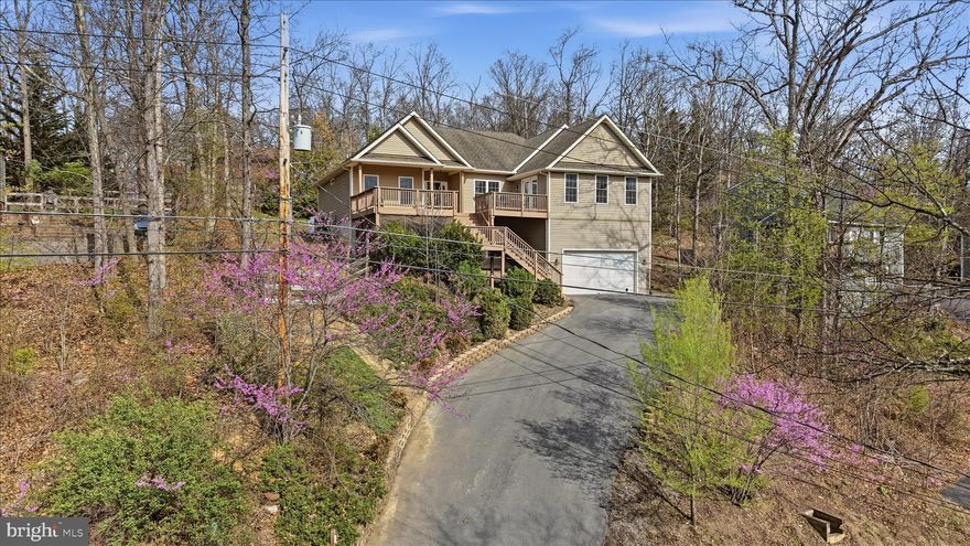 ***OPEN HOUSE THIS SATURDAY, APRIL 11th, FROM 12-2pm!!!***
Fabulous Raised Rancher with Water Views in the Gated Community of Lake Holiday! Perched on a hill to capture beautiful lake views, this home offers the perfect blend of comfort, space, and outdoor living. Enjoy multiple exterior living areas including expansive front decks, a screened-in back porch accessible from both the living room and primary bedroom, and a stone patio—ideal for relaxing or entertaining.
Inside, the open-concept layout features a custom kitchen with granite countertops, upgraded cabinetry, and a spacious adjoining family room, creating the perfect gathering space. Upgraded laminate flooring runs throughout the main living areas, enhancing both style and durability. This home offers a fantastic one-level living option with two incredible primary suites plus two additional bedrooms, providing flexibility for multi-generational living or guests. The unfinished 1,700 sq ft basement with rough-in plumbing presents an incredible opportunity to expand—perfect for creating a full second living quarters and bringing the total finished space to over 4,000 sq ft. Bring your boat and experience everything Lake Holiday has to offer—boating, beaches, clubhouse, walking trails, and more—all within a sought-after 24/7 gated community. Lake living at its best—don’t miss this one!