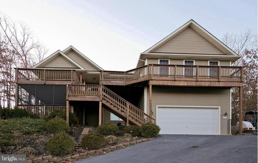 ***OPEN HOUSE THIS SATURDAY, APRIL 11th, FROM 12-2pm!!!***
Fabulous Raised Rancher with Water Views in the Gated Community of Lake Holiday! Perched on a hill to capture beautiful lake views, this home offers the perfect blend of comfort, space, and outdoor living. Enjoy multiple exterior living areas including expansive front decks, a screened-in back porch accessible from both the living room and primary bedroom, and a stone patio—ideal for relaxing or entertaining.
Inside, the open-concept layout features a custom kitchen with granite countertops, upgraded cabinetry, and a spacious adjoining family room, creating the perfect gathering space. Upgraded laminate flooring runs throughout the main living areas, enhancing both style and durability. This home offers a fantastic one-level living option with two incredible primary suites plus two additional bedrooms, providing flexibility for multi-generational living or guests. The unfinished 1,700 sq ft basement with rough-in plumbing presents an incredible opportunity to expand—perfect for creating a full second living quarters and bringing the total finished space to over 4,000 sq ft. Bring your boat and experience everything Lake Holiday has to offer—boating, beaches, clubhouse, walking trails, and more—all within a sought-after 24/7 gated community. Lake living at its best—don’t miss this one!