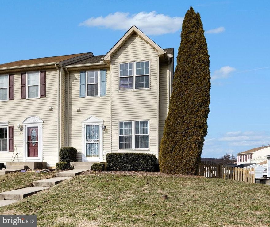 Enter this well-maintained end-of-group townhome into a welcoming main level featuring hardwood floors and a convenient powder room just off the entry. The spacious living room offers an open, comfortable layout that flows naturally into the kitchen and dining area.

The kitchen features white cabinetry, stainless steel appliances, ample counter space, and a center island, with the dining area positioned for easy everyday use and entertaining. Just beyond, a bright four-season sunroom with wood flooring provides flexible living space and leads directly to the expansive rear deck — perfect for relaxing or entertaining.

The upper level offers a generous primary suite with two walk-in closets and a private bath featuring a separate soaking tub and shower. A full hall bath serves the additional bedrooms, both of which are well sized with neutral finishes and ceiling fans.

The walk-out lower level includes an unfinished basement with sliding glass doors, full-size window, laundry area, utility sink, and a bathroom rough-in, offering excellent storage and future finishing potential.

Outdoor living is a standout feature. Enjoy a large composite deck with modern railing overlooking the fenced rear yard. The yard includes a storage shed and usable green space, with the end-unit location providing added privacy and possibilities.

Conveniently located near shopping, dining, and commuter routes, this home offers a strong combination of space, layout, and outdoor living.
