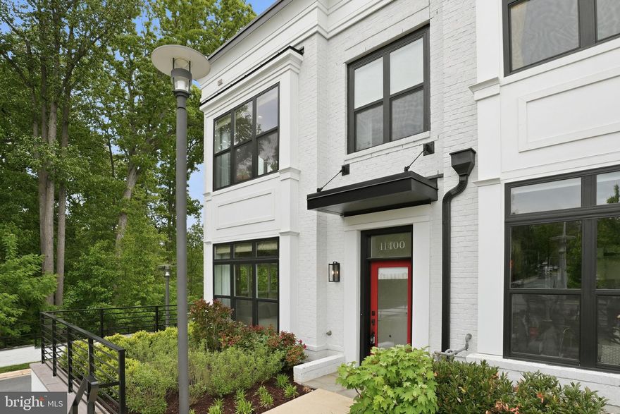 Welcome home to this stunning 4-level EYA elevator townhome offering modern luxury, convenience, and exceptional upgrades throughout. Thoughtfully designed with open spaces, high ceilings, and an effortless flow, this home is perfect for both entertaining and everyday living.

Enter through the foyer and immediately feel the light and airiness created by a dramatic wall of windows overlooking Cabin John Park. This is the only home in the community with this incredible view of trees and greenspace. The private elevator provides easy access to all four levels.

The home is fully wired with Sonos surround sound, in-ceiling speakers, smart security, enhanced WiFi, and multimedia wiring for seamless connectivity. Enjoy the warmth of the gas fireplace while taking in the changing colors of the woods.

The chef’s kitchen features a large island, upgraded luxury appliances, water filtration system, abundant storage, upgraded quartz countertops, and elegant gold accents. A spacious dining area, second sitting area, rear balcony with gas hookup for grilling, and powder room complete this level.

Upstairs, the primary suite is a peaceful retreat with dual walk-in closets and a spacious ensuite bath featuring dual vanities, upgraded tile, and an oversized walk-in shower. A second bedroom with attached full bath and a custom laundry room with sink and extensive storage complete this level.

The top level offers a third bedroom, full bath, and spacious family room opening to a rooftop terrace with retractable awning, seating space, dining area, and a second gas hookup for a grill or fire-pit.

The lower level includes flexible space for an office or gym, another powder room, whole-house vacuum system, and access to the large two-car garage.

All of this just steps from the newly updated Cabin John Village, with dining, shopping, services, and convenient access to I-270 and the DMV.