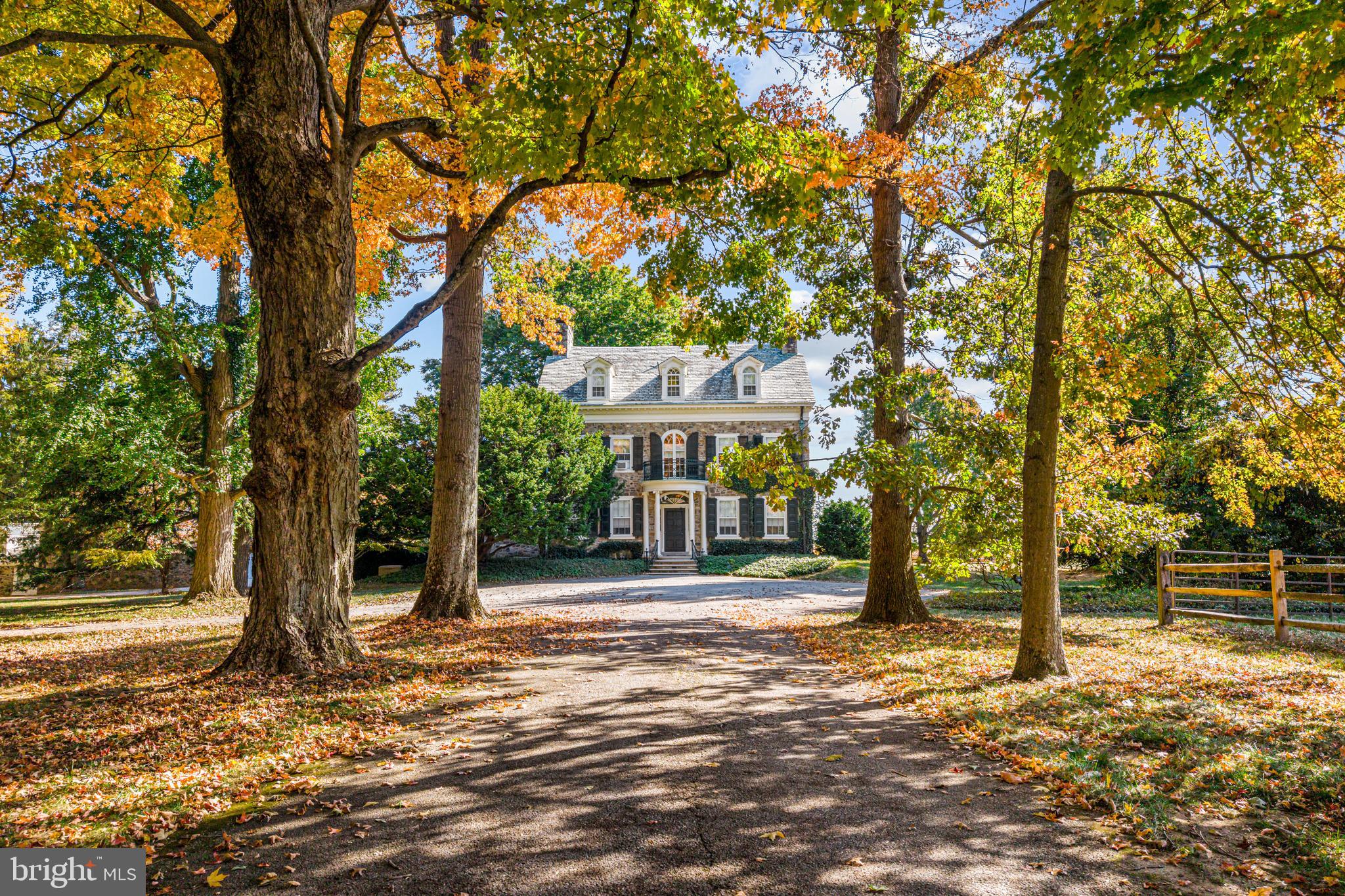 705 Church Rd, Wayne, PA offers a rare chance to own a piece of one of Pennsylvania’s most historic estates. This 7,040 sq. ft. home is set within the renowned Ardrossan estate, a cornerstone of Colonel Robert Montgomery’s legacy. Originally known as Aeola, it was renamed Hopelands in 1929 under his stewardship. In 1930, famed architect Horace Trumbauer renovated the estate. Ardrossan’s heritage extends beyond its grandeur—it inspired The Philadelphia Story, based on Montgomery’s daughter, Helen Hope Montgomery Scott, later adapted into a Hollywood classic starring Katharine Hepburn. This home has been carefully stewarded by the family until now.
Set on 14.4 of the most premium acres in Radnor Township, 705 Church Rd is surrounded by the pastoral beauty that has defined Ardrossan for generations. Thanks to the family’s efforts, the area retains its rolling hills and open landscapes. Today, with 160 acres of the estate now part of Radnor Township parks and nearly 300 acres under conservation easements, these breathtaking views remain preserved. Hopelands is framed by expansive green landscapes, maintaining the historic charm of Ardrossan and its surroundings.
Entering the property on Church Rd, across from the renowned Chanticleer Garden, offers a dramatic first impression. A long, tree-lined drive leads to the stately stone estate. Classic details include a columned entryway, intricate moldings, an elegant front door, a second-floor balcony, period black shutters, dormers, and a circular front drive. To the right, beyond a split rail fence, golden fields of corn and endless vistas stretch across the property. To the left, horse stables, a tennis court, a detached garage with Carriage House, and a dramatic stone gateway and courtyard await. The driveway continues to a second entrance on Abrahams Lane.
This 3-story manor blends Federal and Colonial Revival architecture with luxurious details evoking timeless elegance. Features include original stonework, intricate millwork, wide plank hardwood floors, and period fireplaces. The home’s distinctive architecture is reflected in its classical proportions, a warm foyer, and refined interior with large reception rooms, echoing the sophistication of early 20th-century Main Line estates. Public records list the home’s construction date as 1840, though parts may date back to 1720, with the 30-by-18-foot stone core likely built over a century later.
The main level includes a living room, dining room, library, butler’s pantry, kitchen, walk-in pantry, mudroom, and 2 powder rooms. French doors off the dining room, living room, and library open to brick and stone terraces with sweeping views. The second floor features a spacious primary suite with a fireplace, sitting room, and 2 bathrooms, along with 3 additional large bedrooms and 3 full baths. The third floor is divided into two sections: one with 2 bedrooms and 1 full bath, previously used as a guest room and guest bath, and a music room; the other with 3 bedrooms and 1 bath, originally intended for staff.
This is a once-in-a-lifetime opportunity to own a living piece of history in an extraordinary setting. A grand canvas for restoration, Hopelands at Ardrossan offers prestigious lineage, unparalleled acreage, and timeless design in one of the Main Line’s most coveted locations.
Seize this extraordinary chance to become the next steward of Hopelands at Ardrossan—where history, elegance, and possibility converge.