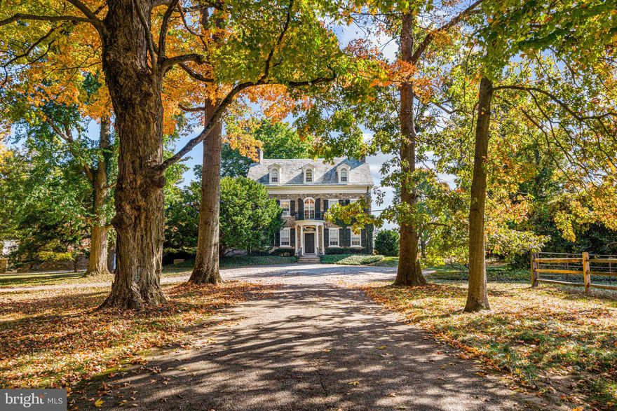 705 Church Rd, Wayne, PA offers a rare chance to own a piece of one of Pennsylvania’s most historic estates. This 7,040 sq. ft. home is set within the renowned Ardrossan estate, a cornerstone of Colonel Robert Montgomery’s legacy. Originally known as Aeola, it was renamed Hopelands in 1929 under his stewardship. In 1930, famed architect Horace Trumbauer renovated the estate. Ardrossan’s heritage extends beyond its grandeur—it inspired The Philadelphia Story, based on Montgomery’s daughter, Helen Hope Montgomery Scott, later adapted into a Hollywood classic starring Katharine Hepburn. This home has been carefully stewarded by the family until now.
Set on 14.4 of the most premium acres in Radnor Township, 705 Church Rd is surrounded by the pastoral beauty that has defined Ardrossan for generations. Thanks to the family’s efforts, the area retains its rolling hills and open landscapes. Today, with 160 acres of the estate now part of Radnor Township parks and nearly 300 acres under conservation easements, these breathtaking views remain preserved. Hopelands is framed by expansive green landscapes, maintaining the historic charm of Ardrossan and its surroundings.
Entering the property on Church Rd, across from the renowned Chanticleer Garden, offers a dramatic first impression. A long, tree-lined drive leads to the stately stone estate. Classic details include a columned entryway, intricate moldings, an elegant front door, a second-floor balcony, period black shutters, dormers, and a circular front drive. To the right, beyond a split rail fence, golden fields of corn and endless vistas stretch across the property. To the left, horse stables, a tennis court, a detached garage with Carriage House, and a dramatic stone gateway and courtyard await. The driveway continues to a second entrance on Abrahams Lane.
This 3-story manor blends Federal and Colonial Revival architecture with luxurious details evoking timeless elegance. Features include original stonework, intricate millwork, wide plank hardwood floors, and period fireplaces. The home’s distinctive architecture is reflected in its classical proportions, a warm foyer, and refined interior with large reception rooms, echoing the sophistication of early 20th-century Main Line estates. Public records list the home’s construction date as 1840, though parts may date back to 1720, with the 30-by-18-foot stone core likely built over a century later.
The main level includes a living room, dining room, library, butler’s pantry, kitchen, walk-in pantry, mudroom, and 2 powder rooms. French doors off the dining room, living room, and library open to brick and stone terraces with sweeping views. The second floor features a spacious primary suite with a fireplace, sitting room, and 2 bathrooms, along with 3 additional large bedrooms and 3 full baths. The third floor is divided into two sections: one with 2 bedrooms and 1 full bath, previously used as a guest room and guest bath, and a music room; the other with 3 bedrooms and 1 bath, originally intended for staff.
This is a once-in-a-lifetime opportunity to own a living piece of history in an extraordinary setting. A grand canvas for restoration, Hopelands at Ardrossan offers prestigious lineage, unparalleled acreage, and timeless design in one of the Main Line’s most coveted locations.
Seize this extraordinary chance to become the next steward of Hopelands at Ardrossan—where history, elegance, and possibility converge.