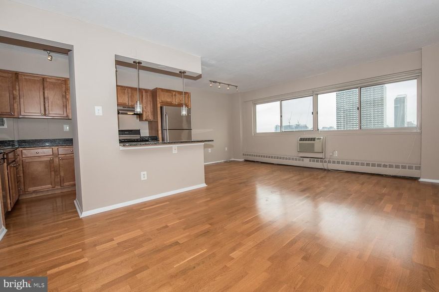 Fabulous Rittenhouse Square Location! Fully upgraded with gleaming wood floors, expansive windows that fill the space with light, sweeping city views from the 15th Floor, custom lighting, and plenty of storage space. This is the most attractive and largest 1-bedroom unit in RiverWest. Open-layout gourmet kitchen features ample cabinetry, granite counters, large L-shaped working space, stainless steel appliances, gas range, and a spacious breakfast bar with pendent lighting. Spacious bedroom, ample closet space. Fully renovated bath with gorgeous marble tile, chrome fixtures, granite counter, and storage vanity. Building amenities include state-of-the-art fitness center, 24-hour concierge and 2 convenient restaurants. ALL UTILITIES INCLUDED (gas, water, and electricity), basic cable TV, building insurance, onsite maintenance, a state of the art fitness center, and 24 hour lobby attendant. Onsite garage parking is also available for an additional monthly fee. Close to restaurants, shopping, theaters and public transportation, this apartment at Riverwest is in the center of it all. The campuses of Penn and Drexel, 30th Street Station and major hospitals are all just minutes away.  Automatic ice maker is not functional.