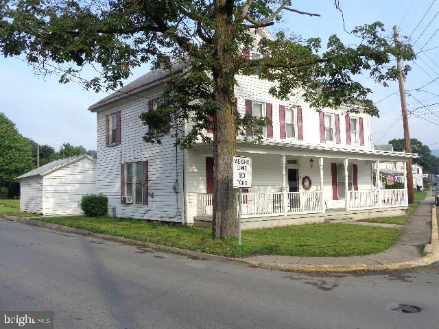 Charming 2 story with 4-5 bedrooms, 2 baths, 1st floor laundry, pocket doors & 2 staircases. Home has original woodwork, 3 fireplaces (non-functioning) and a pellet stove. Property includes rental mobile home and oversized 2 story garage that is great for workshop, car collector, etc. No zoning means endless possibilities. NOT in flood zone, seller has LOMA letter.