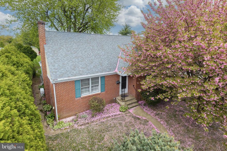 Charming brick Cape Cod located in the heart of Souderton Borough with a beautiful backyard setting and picturesque alley access. Enjoy the convenience of walkability to local cafes, restaurants, Wawa, Dunkin, grocery stores, schools, and nearby parks, offering the perfect blend of small-town charm and everyday convenience. Step inside to a spacious and inviting living room featuring double windows for natural light and genuine hardwood flooring that continues throughout most of the home. The dining area includes recessed lighting and access to the enclosed porch, an ideal space for dining, entertaining, relaxing picnic-style, or simply enjoying peaceful backyard views in comfort. The kitchen offers new vinyl flooring, oak cabinetry, neutral countertops, porcelain sink, garbage disposal, and a full appliance package including refrigerator, electric range, microwave, dishwasher. The first-floor full bath has been  updated with a new walk-in shower, new flooring, pedestal sink, and toilet. Two bedrooms are located on the main floor. The primary bedroom features overhead lighting and a double closet, while the second bedroom also includes overhead lighting, 2nd bedroom can provide flexibility for guest room, office space, or hobbies,. Upstairs, you’ll find two additional spacious bedrooms with double closets, cubby storage space, and a convenient full bathroom featuring a tub with pretty tile surround. The full basement includes a semi-finished area, washer and dryer, Bilco doors, and a newer hot water heater installed in 2021. Outside, the gorgeous level yard offers a wonderful space to relax or entertain, complete with a mature shade tree, a small storage shed, and an oversized one-car garage-style shed near the driveway for additional storage or workspace.