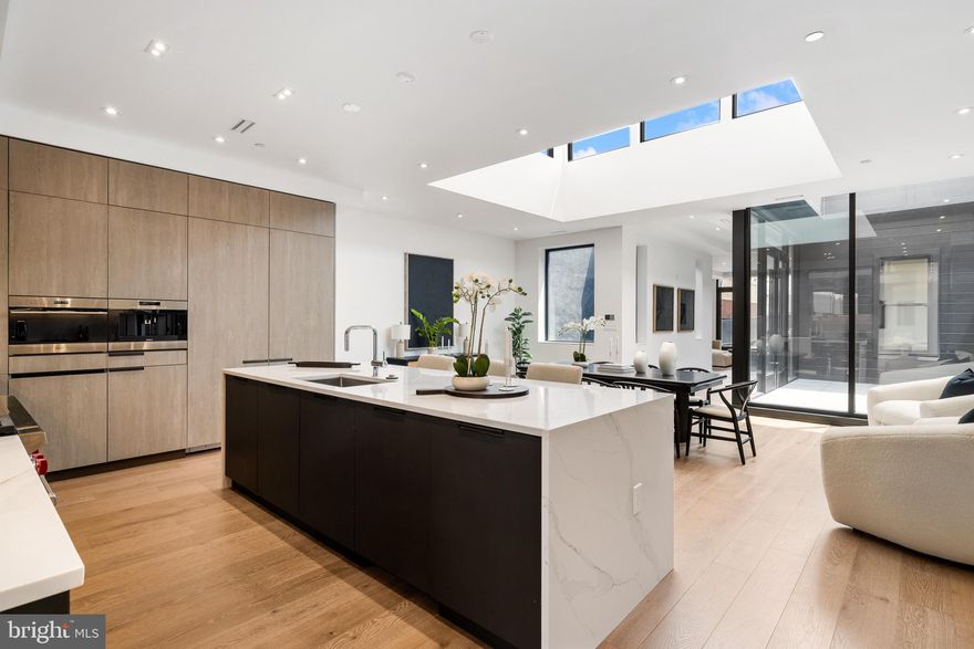 A rare opportunity to own one of Old City’s most coveted residences, this bi-level penthouse spans the entire fifth and sixth floors of an exclusive four-unit building. Set high above the cobblestone streets and historic charm of the neighborhood, this bespoke home is developed by Astoban Investments, renowned for their innovative design and exceptional craftsmanship. Combining architectural distinction, scale, and complete privacy, this penthouse represents an exceptional offering rarely available in Philadelphia’s elite market. Spanning 4,786 square feet across two floors accessible by private elevator, the penthouse is designed for entertaining and practical living. The lower level is thoughtfully arranged with four generously proportioned bedroom suites, each featuring its own ensuite bath and custom walk-in closet. A central lounge with built-in kitchenette creates an ideal space for guests or extended living. The primary suite is a sanctuary unto itself, featuring radiant heated floors, a custom steam shower, Scavolini vanities, and elegant fixtures by Fantini, Dornbracht, and Grohe. The walk-in closet is outfitted with floor-to-ceiling exposed built-ins and extensive hanging space, delivering exceptional functionality. Ascend to the upper level and discover a seamless blend of indoor-outdoor living. The chef’s kitchen, crafted in Italy by Scavolini, anchors the space with a striking 48” Wolf gas range, built-in coffee system, 30” Sub-Zero wine fridge, and bookmatched Calacatta stone countertops. A dramatic dining area with 15-foot ceilings opens onto an interior atrium, offering a tranquil open-air escape at the center of the home. Beyond, a nearly 700-square-foot private terrace provides the perfect backdrop for al fresco dining and cityscape views. At the opposite end, a glass-enclosed great room, also with soaring 15+ foot ceilings, offers a versatile retreat for a media lounge, library, or executive office, all bathed in natural light. Throughout the home, high-caliber finishes define every surface: wide-plank Austrian oak flooring, two-zone Daikin HVAC, Porcelanosa tilework, frameless glass showers, custom cabinetry, and integrated smart home systems including Nest keyless entry and ButterflyMX video intercom. One garage parking space is included with the option to purchase a second, and a full 10-year tax abatement adds long-term value. The original 1920s façade complements the character of the neighborhood, while the interior is newly built - a seamless fusion of historic charm and contemporary design. Ideally situated just five minutes from I-95, with New York City under 90 minutes away. The highly anticipated transformative I-95 capping project, currently underway, will soon deliver landscaped parks, expanded green space, and a vibrant riverfront promenade that redefines Old City’s connection to the waterfront. For the discerning buyer seeking exclusivity, scale, and sophisticated design, this is a rare opportunity to own a private custom-designed penthouse in one of Philadelphia’s most historically rich and dynamically evolving neighborhoods.