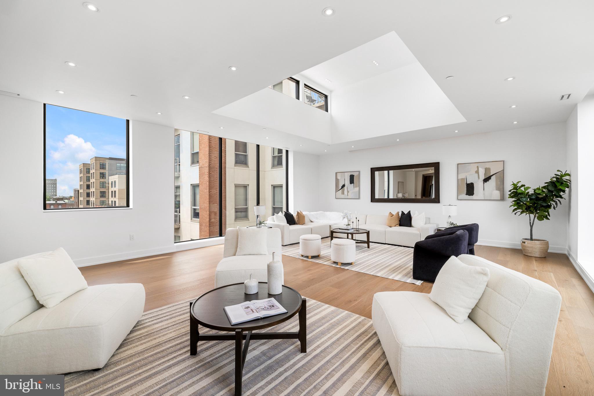 A rare opportunity to own one of Old City’s most coveted residences, this bi-level penthouse spans the entire fifth and sixth floors of an exclusive four-unit building. Set high above the cobblestone streets and historic charm of the neighborhood, this bespoke home is developed by Astoban Investments, renowned for their innovative design and exceptional craftsmanship. Combining architectural distinction, scale, and complete privacy, this penthouse represents an exceptional offering rarely available in Philadelphia’s elite market. Spanning 4,786 square feet across two floors accessible by private elevator, the penthouse is designed for entertaining and practical living. The lower level is thoughtfully arranged with four generously proportioned bedroom suites, each featuring its own ensuite bath and custom walk-in closet. A central lounge with built-in kitchenette creates an ideal space for guests or extended living. The primary suite is a sanctuary unto itself, featuring radiant heated floors, a custom steam shower, Scavolini vanities, and elegant fixtures by Fantini, Dornbracht, and Grohe. The walk-in closet is outfitted with floor-to-ceiling exposed built-ins and extensive hanging space, delivering exceptional functionality. Ascend to the upper level and discover a seamless blend of indoor-outdoor living. The chef’s kitchen, crafted in Italy by Scavolini, anchors the space with a striking 48” Wolf gas range, built-in coffee system, 30” Sub-Zero wine fridge, and bookmatched Calacatta stone countertops. A dramatic dining area with 15-foot ceilings opens onto an interior atrium, offering a tranquil open-air escape at the center of the home. Beyond, a nearly 700-square-foot private terrace provides the perfect backdrop for al fresco dining and cityscape views. At the opposite end, a glass-enclosed great room, also with soaring 15+ foot ceilings, offers a versatile retreat for a media lounge, library, or executive office, all bathed in natural light. Throughout the home, high-caliber finishes define every surface: wide-plank Austrian oak flooring, two-zone Daikin HVAC, Porcelanosa tilework, frameless glass showers, custom cabinetry, and integrated smart home systems including Nest keyless entry and ButterflyMX video intercom. One garage parking space is included with the option to purchase a second, and a full 10-year tax abatement adds long-term value. The original 1920s façade complements the character of the neighborhood, while the interior is newly built - a seamless fusion of historic charm and contemporary design. Ideally situated just five minutes from I-95, with New York City under 90 minutes away. The highly anticipated transformative I-95 capping project, currently underway, will soon deliver landscaped parks, expanded green space, and a vibrant riverfront promenade that redefines Old City’s connection to the waterfront. For the discerning buyer seeking exclusivity, scale, and sophisticated design, this is a rare opportunity to own a private custom-designed penthouse in one of Philadelphia’s most historically rich and dynamically evolving neighborhoods.