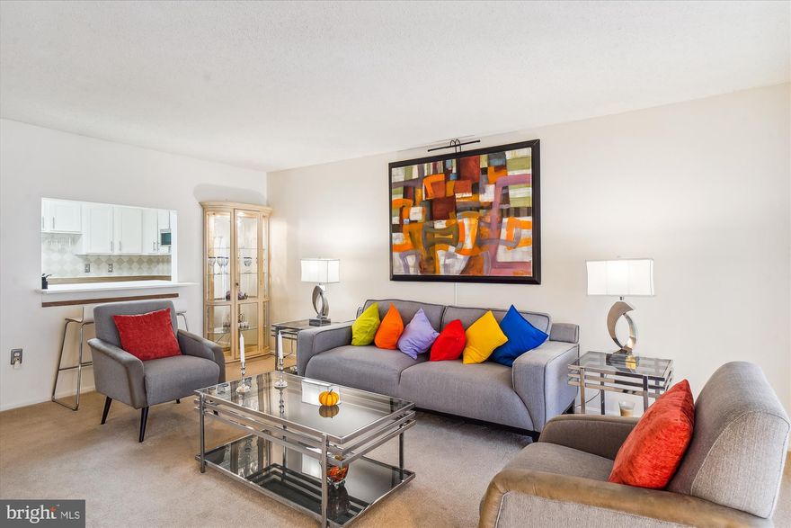 Bright & sunny second floor G-G model condo located in a premier 55+ community.  Meticulously kept, this unit is move-in ready.  Updated kitchen with white cabinetry, like-new stainless steel appliances and built-in bar seating.    The kitchen opens to a spacious dining room, living room, and enclosed sunroom offering plenty of space to relax and entertain.  The primary suite offers a large closet and a walk-in shower in the bathroom.  The second bedroom/den features built-in cabinets for extra storage.  In unit washer and dryer with extra storage space.  Condo fee includes trash, water, high speed internet and cable TV as well as access to amenities.  This community has it all including a golf course, gated security, indoor and outdoor swimming pools, a fitness center, art studio, woodshop and more!