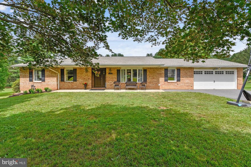 Great opportunity for an updated Brick Rancher with an attached 2-car garage and walk-out level basement.  The kitchen features high-end cabinets, granite countertops, stainless steel appliances, including a new microwave and dishwasher, an oversized island with seating & storage. The large open floor plan is great for entertaining, with a large dining area.  The stunning wood-burning fireplace and hardwood floors on the main level make this a very warm and welcoming space. The family room leads to a large deck with views of the 1.23-acre lot with mature trees bordering the property. Enjoy 4 spacious bedrooms & 2 full baths on the main level.  The finished lower level features an open family room with a separate laundry room, storage room, a half bath, and two additional rooms that could be an office, gym, or guest room, and a walk-out level rear entrance.  There is a newer well pressure tank and a UV whole-house water filter.  A new septic system and a recently repaved driveway.