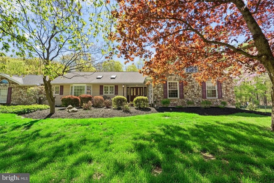 Welcome to 5774 S Deer Run Road, an exceptional, oversized ranch residence set on just over an acre in the coveted Hunters Run enclave of Buckingham Township. Framed by mature landscaping and classic stonework, the home presents a timeless façade and exceptional curb appeal. A gracious double-door entry opens to a sunlit foyer, where a coffered ceiling and refined architectural details establish an elegant tone. The formal dining room is both striking and inviting, anchored by a gas fireplace and a wall of windows that bathe the space in natural light, an ideal setting for memorable gatherings. At the heart of the home, the thoughtfully designed kitchen blends function and style with rich cherry cabinetry, a granite island, stainless steel and paneled appliances, new dishwasher, and a skylight that casts a soft, ambient glow. The adjoining breakfast area, framed by triple windows, offers serene views of the front grounds. The great room provides a comfortable yet sophisticated retreat, perfect for both relaxed evenings and lively entertaining, complemented by a second gas fireplace nestled within a cozy alcove. French doors lead to a spectacular covered patio with a vaulted ceiling, ceiling fan, and awning, creating a seamless indoor-outdoor experience. Beyond, a newly retiled in-ground pool overlooks the expansive, fenced backyard, offering a private setting for summer entertaining. Everyday living is enhanced by a spacious mudroom with Electrolux washer and dryer, a powder room, and direct access to the attached two-car garage, providing both convenience and ample storage. The primary suite is a peaceful sanctuary, featuring two generous closets and a well-appointed en-suite bath with an oversized double vanity. Three additional bedrooms are equally well-proportioned, each with ample closet space, and share a hall bath with a double vanity and tub-shower combination. UV water filtration, generator hookup, and a fantastic full basement with exterior cellar doors. Located within the award-winning Central Bucks School District and just moments from the dining, shopping, and charm of Peddler’s Village, this distinguished property offers the ease of refined single-level living in a premier Bucks County setting. Arrange your private showing and experience all that this remarkable home has to offer.