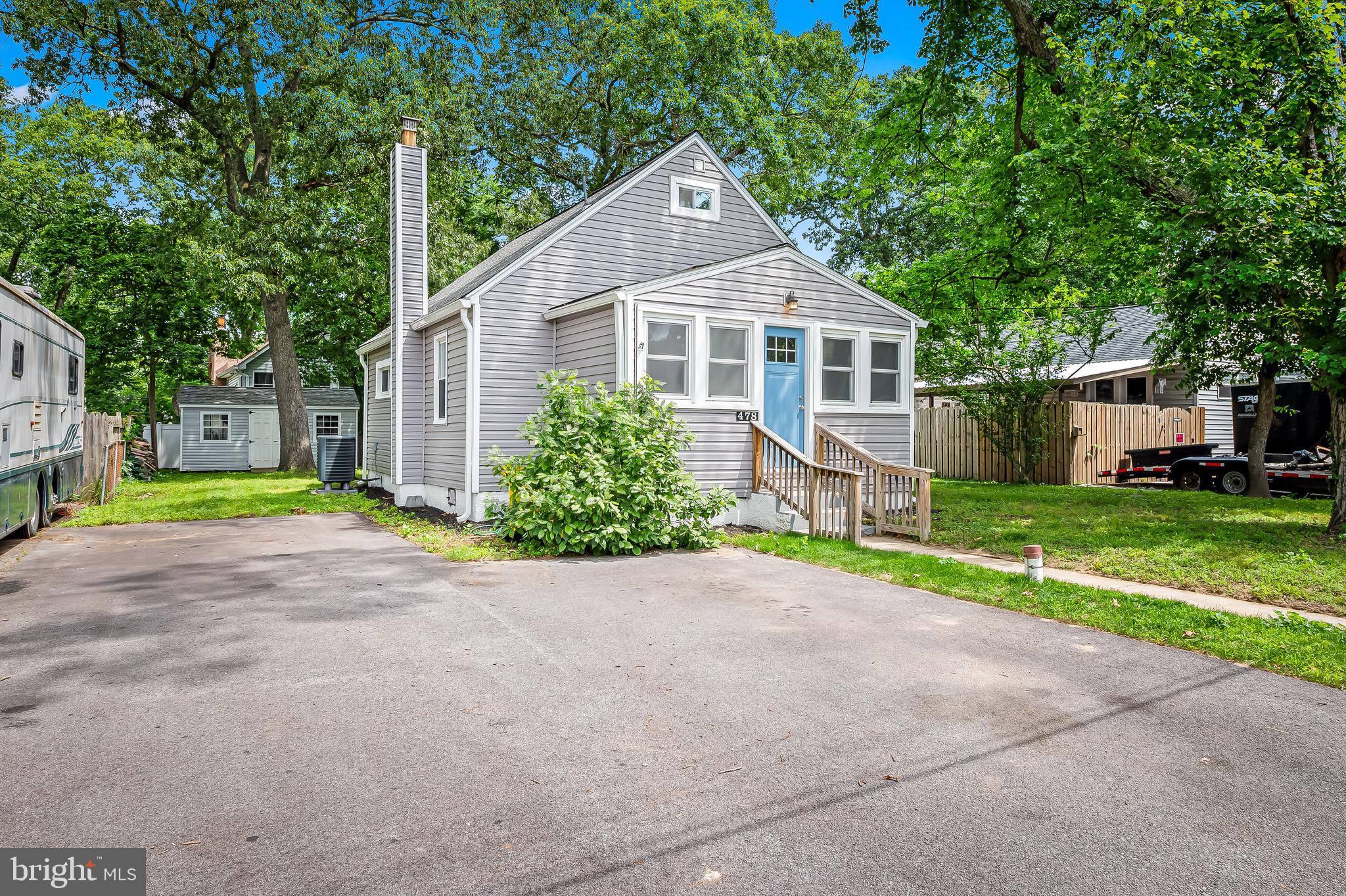 Blocks from the Magothy, this 2021 renovated Cape Cod shaded by a mature tree canopy, offers function and comfort. Through the front door, a windowed foyer is more akin to a sunroom that leads to a quaint living room with two adjacent ample bedrooms and one of the two full baths. Towards the rear, the kitchen, with an optimal layout is well lit with plenty of working surface space. Just beyond, a versatile walkout flex space could be a den or dining; a discrete laundry space is in the corner. Upstairs, a primary suite feels cozy within the geometry of the roof lines. Out to the seemingly secluded yard, one finds a space with boundless potential for relaxation or entertaining. A large, windowed shed provides near garage-level storage or workshop potential.