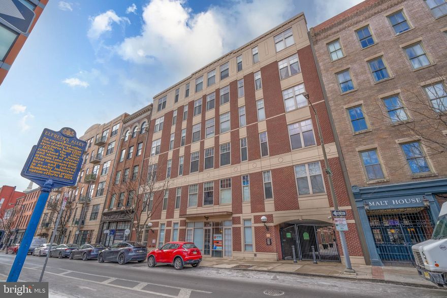 Discover The National in Old City!
Experience the ultimate blend of style, comfort, and location in this stunning two-bedroom, two-bath, open-concept condo on the seventh floor of Old City’s esteemed community. This exclusive five-building development boasts exceptional amenities, including an on-site underground parking garage and a private, gated courtyard. This west-facing unit provides breathtaking views of the Center City skyline , The Ben Franklin Bridge and best enjoyed from your private deck. This condo boasts soaring 11-foot ceilings, exposed poured concrete complemented by spiral ductwork, and custom lighting. The walls are beautifully painted, and the cork flooring throughout adds warmth and character. The modern kitchen is a chef’s dream, featuring top-of-the-line stainless steel appliances, including a Wolf oven with a glass-top stove, a Bosch dishwasher, and a Thermador refrigerator. Custom white cabinetry, a distinctive tile backsplash, and Caesarstone countertops complete the sophisticated design. Both the living room and the primary bedroom showcase striking accent walls adorned with floor-to-ceiling rectangular tiles. The primary bedroom also includes a walk-in closet upgraded with custom organizers for maximum convenience. Parking is a breeze with your own deeded space in the underground garage and bike storage both easily accessible via the building’s elevator. Nestled in the heart of Old City, The National is just steps from Elfreth's Alley, Philadelphia’s finest restaurants, coffee shops, boutiques, art galleries, and historic landmarks. Immerse yourself in the neighborhood’s vibrant culture, from annual events like Old City Fest to First Friday evenings, where galleries and studios open their doors to art lovers. This dynamic community combines historic charm with modern energy, offering an unparalleled lifestyle in one of the city’s most coveted locations. Don’t wait—schedule your appointment today. This extraordinary opportunity won’t last!