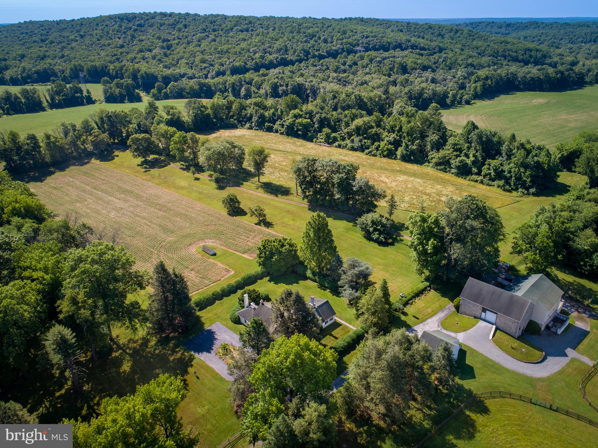Situated in the heart of East Nantmeal Township is this exquisite 30 acre estate. The farm immediately welcomes you with a long tree lined driveway leading to home, barn and pastures. The property is privately situated on the 30 acres and is surrounded by 344 acres of restricted land. The home boasts 4,450 square feet with a charming foyer, grand living room with high ceilings, formal dining room, formal sitting room and a large kitchen and mudroom. Each room is spacious and features beautiful fireplaces and hardwood floors. You will also find a 4 seasons sun room with an expansive view and access to the back patio and lawn. Enjoy your cup of coffee while watching birds and wildlife. The second floor features 3 bedrooms and 2 full bathrooms with two staircases and a 3rd floor attic with ample storage and a cedar closet. The equestrian will love to have their horses stabled in this 8 stall barn that includes ample pasture with run in sheds. The large bank barn also has room for tractors and any farm equipment as well as a bonus woodworking room! This is a rare opportunity to own an exceptional farm in a sought after area. Please contact us so we can show you a tour of this exquisite property.