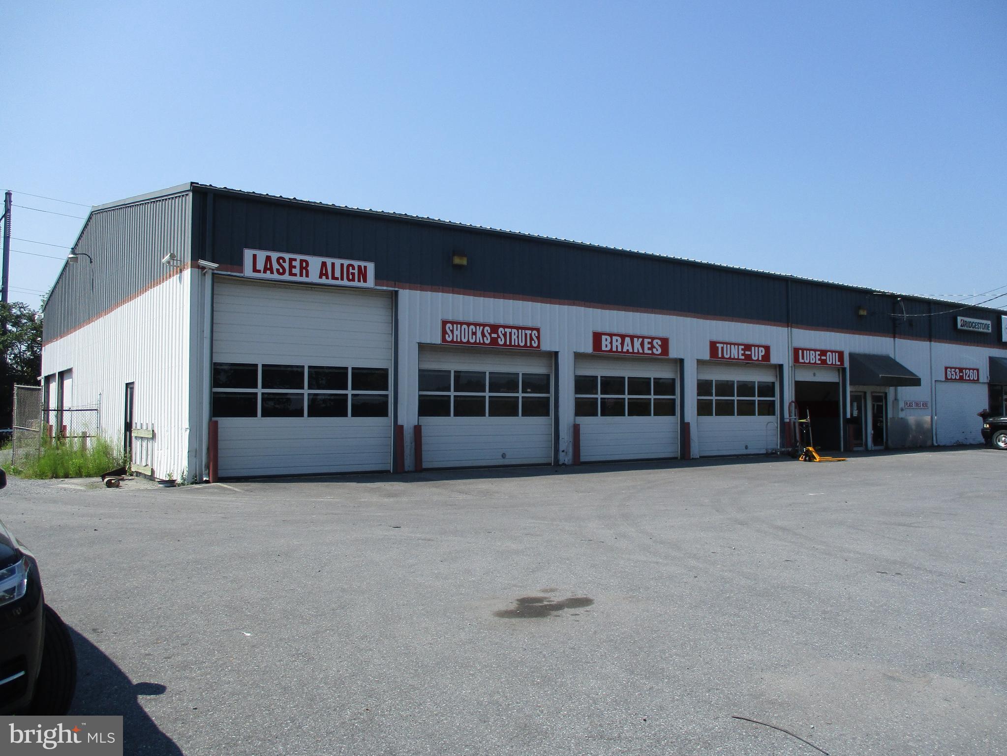 This 2.1 acre Mount Joy Township commercial property is conveniently located between Mount Joy and Rheems / Elizabethtown along Rt. 230. This property has been used as a retail tire sales business for cars, trucks and agricultural equipment. This property has ample parking for customers or employees with a paved, level parking area with great visability. There is a gravel storage / parking area that is approx 100' by 190' in size with a chain link fence for security. The original building was built in 1977 and is 80' wide by 160' long, or 12,800 square feet in size. This building has five overhead doors on the front that faces Rt. 230. One door is 14' high by 14' wide, three doors are 10' high by 14' wide and one door is 10' high by 10' wide. This building also has two additional overhead doors on the left side, and both these doors are 10' high by 12' wide. This building has a large showroom / waiting area for customers. There is ample space with offices, and public restrooms. This building has a break room with lockers and eating area for employees. This building has significant upper level storage area and built in storage area on the ground floor. This clear span building building offers great flexibility to be changed to fit the needs of the new owner. There is a second building on this property that is 100' by 125' with a 19' overhang on the 125' front. This 12,500 square foot building was built in 1985 and was used as a warehouse. this building has four structural poles that run down the middle for support. this building has a concrete floor, and office and two levels of storage above the ground floor. These two upper level storage areas could be modified or removed to suit the needs of the new Buyer. This building has a 14' high by 22' wide overhead door that faces the road. This property has no loading dock, and the two buildings are connected by an upper level catwalk that could be modified or removed. This property has three phase power, and has a 400 amp service to each building with a meter on each building. This property has a drilled well and the sewage is pumped into the public system through an easement that runs through two neighboring properties. This comercially zoned property could be uses for a variety of uses, is located along a well travelled road and has been a visable business location for many decades. The Seller would consider a lease with the right terms and conditions.