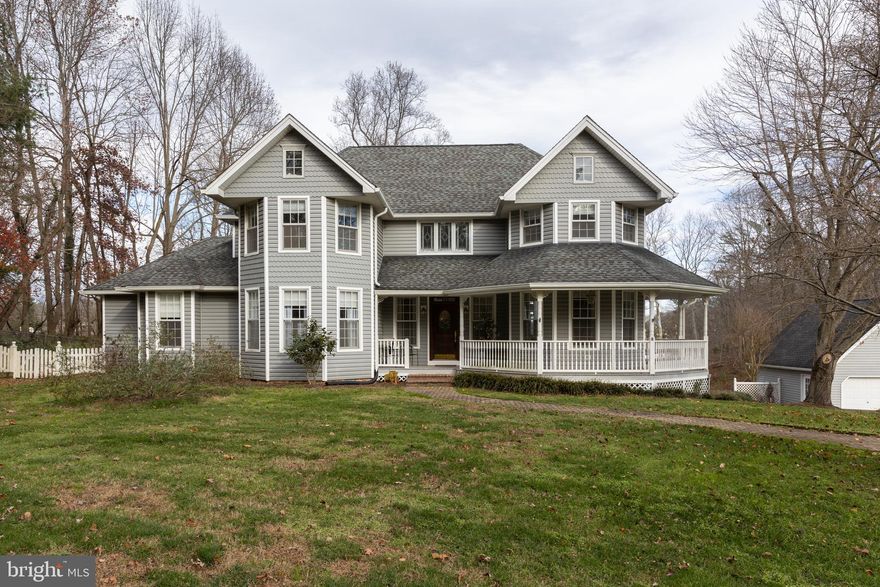 IMPECCABLE WATERFRONT HOME. Walk up to this beauty on a paver walkway, landscaping galore. Walk on to the wrap around porch, sit and relax on those crisp early mornings or evenings. Enter through the front door, into a very inviting foyer area with spiral wooden staircase. The Kitchen is the envy of the home, brand new granite counter tops with room for seating, gas cooktop, 3 wall ovens for the serious baker, cabinets galore, wet bar with under counter refrigerator, granite bar area, and a wine rack. Next to the open kitchen is a sitting area with 1 of the gas fireplaces for those cool evening, looking at the picture perfect water view. Next comes the main level laundry room with tile floors and granite counter tops for folding and a half bath. Don't over look the large dining room, easily will sit eight or more. The living room, with a 2 story ceiling, the 2nd gas fireplace, custom white book cases, with views of the waterfront also. 8 ft. French doors is a bonus that leads to outside deck. Refinished hardwood on most of the main level, crown moulding through out on both levels and chair railing. Recessed lighting through out. The master bedroom is on the main level, tray ceilings with walk in custom closets, master bath has separate vanities, stand up tiled shower, stand alone soaking tub, with water closet and door that leads also to the rear deck. Home office next to master bedroom, large enough for 2 desks, with built in book cases. More upstairs to the 1st bedroom, all with a bathroom, the 2nd and 3rd bedrooms sit on either side of a full bath with separate water closet and shower.  The basement also has a full bathroom, an extra work out room, home school, or office space. Room in the storage area or work bench. Walk out on the enclosed sunroom for entertaining in bad weather that also leads to a large rear deck for grilling and large family gatherings. Move outside to a large detached 2 car garage for storage for your toys with a unfinished loft area, can be turned into added living area or man cave. There is a fenced in area on the side of the home for pets to roam. Walk down to the waterfront to a pier that has a relaxing area, a boat lift, and a lift for other toys, the pier is about 6 ft. wide about 100 ft. long. Enjoy fishing and crabbing on your days off. WELCOME HOME.