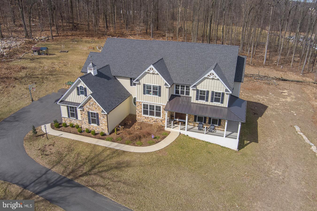 Welcome to this rare opportunity to own an exquisite custom designed estate home situated on a breathtaking 7.4 acres in the heart of Chester Springs. Custom built in 2019, this secluded paradise features sprawling grounds, mature landscaping and spectacular views from every window of the home, offering every upgrade and amenity imaginable. This beautifully hand-crafted masterpiece offers the finest in architectural detail with over 7,400 square feet of living space in three levels including 5 Bedrooms, 4 full Bathrooms, 2 half Baths, 2 fireplaces, oversized 3-car garage and a professionally designed walkout Lower Level. The handsome exterior features James Hardie-board siding w/real cut stone accents, craftsman style Andersen windows, inviting front & side porch w/metal roof accent & a lighted cupola w/copper roof. Enter the Main Level to view the expansive and inviting open floor plan featuring stunning front-to-back Foyer, hickory hardwood floors throughout, wainscoting and extensive custom millwork detail and high end designer lighting fixtures. State-of-the-art Gourmet Kitchen features Viking stainless professional appliances including 6-burner gas cooktop & range hood, oversize refrig & convection double wall oven. Large walk-in Pantry & the separate 2nd Prep Kitchen are a chefâs dream plus a Butlerâs Pantry w/beverage refrig, glass cabinetry & wet bar, ideal for entertaining. Vaulted Family Room offers 9â custom solid wood beams & oversized woodburning stone fireplace w/reclaimed barn wood beam; Living Room w/custom millwork & gas fireplace; Dining Room with spectacular views of the Chester County countryside; a large Study ideal for work-from-home & formal Powder Room are nicely situated in the rear of the home. Mudroom features 6 custom built cubbies, pet crate room, informal Powder Room, 2 closets and back staircase. 2nd Level features staircase w/upgraded rails & wrought iron spindles; luxury Master Suite with Sitting Room, vaulted ceiling w/custom millwork detail, his & hers closets & gorgeous Master Bath w/jetted Kohler tub, large pebble floor stall shower & separate vanities; 4 additional Family Bedrooms plus Jack ân Jill Bath & Hall Bath; convenient 2nd floor Laundry Room with custom cabinetry & sink. Daylight walkout Lower Level offers 9â ceilings, custom wainscoting, Media Room area plus 2 addâl Game Room/Family Room areas, full Bathroom w/pebble floor stall shower, Professional Gym w/flecked rolled rubber flooring, 2nd Laundry Room & pre-plumbing and wiring for future bar area. Additional amenities include recessed LED lighting throughout, bullnose drywall finishes, holiday candle lighting package, front firepit, custom exterior stone walls and much more. Donât miss this exquisite newly built custom dream home, beautifully secluded in paradise and surrounded by the horse trails of Chester Springs, yet close to award-winning schools, shopping, restaurants and the PA Turnpike. A perfect place to call home!