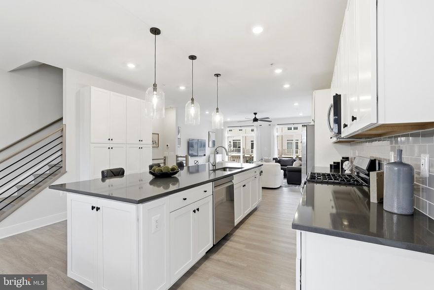 DOWNTOWN BRAMBLETON LIFESTYLE! Own, live, entertain, & grow in this marvelous upscale low-maintenance home w/its breathtaking UNOBSTRUCTED PANAROMIC views of BRAMBLETON GOLF COURSE(18-HOLE w/a DRIVING RANGE)from all its levels! END, FOUR-LEVEL Townhome lives like a single-family! Absorb the warm morning SUNRISES & golden afternoon SUNSETS from this incredible desirable NORTH-EAST facing front door! Extend your indoor living to outdoors! REAR DECK off of FAMILY thru 2 SETS of SLIDING GLASS DOORS(glass transom above)& FRONT ROOFTOP TERRACE off of LOFT thru a SLIDER for your very own yard in the sky, an elevated private oasis for relaxation & entertainment.<br><br>Striking exterior w/its distinctive architecture! An urban-inspired brick facade, black framed windows, front stoop, & single lite glass front door(transom above). An attached 2-CAR rear entry garage w/garage door opener, exterior keypad, & electric car charger + sizeable driveway.<br><br>Modern interior design w/thoughtful features & finishes! Open floorplan that accomplishes contemporary living w/its space & style, versatility & functionality. Nearly 3000 sq ft w/4 spacious bedrooms, 3 luxury full baths handsomely appointed w/ceramic tiles + upgraded countertops, & 2 half baths. 9-FOOT ceilings at all levels & numerous windows thru out maintaining ventilation & keeping the home airy at all times. Single-panel doors w/modern trims, OAK staircase w/horizontal iron bars at all flights, wide plank LVP floors at main level, hallways, & loft. Few attributes to add are CAT 6 home technology structed wiring package, LED recessed lighting, USB outlets, programmable thermostats, insulated garage door, custom blinds, ceiling fans, & media points.<br><br>FOURTH_UPPER 2 LEVEL offers a unique combination! A retreat! Charming LOFT w/a ROOFTOP TERRACE, your own outdoor lounge for your morning coffee, evening sunset cocktails, or movie nights under the stars. In addition, this level draws a bedroom w/walk-in closet & a bath w/walk-in shower. FIRST_LOWER LEVEL greets to a long hallway that houses a coat closet, half bath, & an access to the garage. Home office w/DOUBLE GLASS DOORS & a deep closet which identifies as a bedroom as well; cater this room to your family needs. SECOND_MAIN LEVEL welcomes to an amazing kitchen w/42" wall cabinets, chic hardware, soft-close feature, pull out trays for bottom cabinets, quartz countertops, subway backsplash, SS appliances, pendants, & Chef's pantry wardrobe. Boasts massive vast 11-FOOT center island that can serve as a generous workspace/a spot for homework/space for meals/gathering area & comes w/ample cabinets & a single bowl stainless steel undermount sink w/Kohler polished chrome pull down faucet. Inviting family w/access to DECK, sizable dining overlooking the golf trees, & a powder rm w/a window complete this level. THIRD_UPPER 1 LEVEL opens to large owner's suite featuring two walk-in closets & a generous bath w/dual vanities, large walk-in shower, linen, & a water closet. On the other end of hallway is a guest suite w/its attached bath; wow comes w/a window. To carry on, are the washer-dryer area & a linen closet.<br><br>Walk to BRAMBLETON TOWN CENTER! At your doorstep, just moments away are State of the Art Library, One Life fitness, dining, farmers market, groceries, movies, gas station, restaurants, pharmacy, boutiques, meeting places, & two daycare centers.<br><br>HOA includes Verizon FIOS package for cable & internet, lawn mowing, trash, & snow removal. Access to 5 community pools, 3 club houses available to rent, 18 playgrounds & tot lots, 18+ miles of paved trails across the neighborhood, more than 250 acres of green space, a wide array of parks, beautiful laid ponds w/fish, lighted tennis, sand volleyball, basketball, children’s zipline, bike track, dog park, & little library. Association offers programs like art, dance, drama, summer camps for all ages, & community seasonal events organized throughout the year.