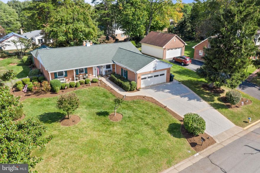 What a great opportunity to own a lovely traditional-style, one-level all-brick home in the heart of Manassas City!  **Nestled in a huge yard this amazing rambler features  4 generously sized bedrooms, 2.5 baths,  and a  2-car garage.   **  A separate Dining Room offers the perfect place to celebrate Sunday dinner and special events!   **Relax and retreat to the glow of the gas fireplace in the spacious family room with vaulted ceiling and skylights.  ** Preparing meals will be a joy in the remodeled expanded kitchen (17'x15') featuring upgraded cabinets, granite counters, a stainless sink, and a large adjacent breakfast area (15'x14').   Surrounding this home is a beautifully landscaped yard with a deck, mature trees, a country-style covered front porch, stamped concrete walkway, and a driveway.    Other extras include a leaf guard gutter system,  extra insulation on the attic,  and an attic fan.  This property backs to a  community walking path.