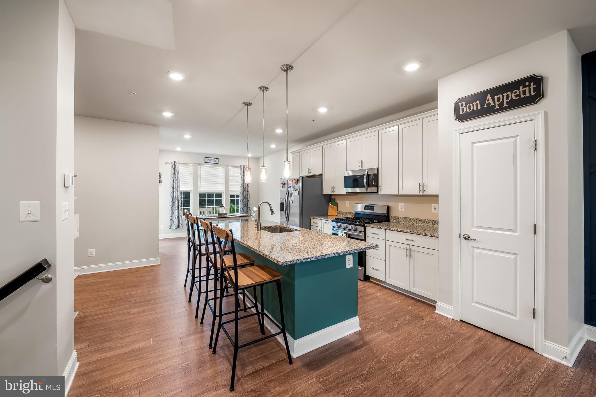 Turn-Key Home!!! All the style of a new build without the wait!!! Welcome to 403 Dryden Road, a modern and meticulously kept townhouse that exudes pride of ownership. The entry level presents a versatile rec room or flex space and a large 4th bedroom complete with a convenient full bathroom. Ascend to the main living level, where LVP flooring spans an open floor plan anchored by a statement accent wall. The spacious kitchen is a standout with granite countertops, a generous center island, abundant white cabinetry, stainless steel appliances, and pendant lighting that frames the dining area. Natural light pours in through the large windows, illuminating the flow from dining to living space—the perfect setting for entertaining or everyday comfort. Upstairs, the third level hosts three well-appointed bedrooms, including a serene primary suite with a generously sized walk-in closet, sitting area and private bath. A centrally located laundry area adds notable convenience. Outdoors, the fully fenced backyard is a true entertainer’s retreat, featuring a stamped concrete patio and a sturdy gazebo structure that overlooks lush green space—ideal for al fresco dining and leisure. 403 Dryden Road blends style, function, and thoughtful upgrades—from the eye-catching accent walls and engineered flooring to the spacious layout and outdoor sanctuary. This standout townhouse is move-in ready and perfect for those seeking flexible living and exceptional attention to detail. Community amenities includes clubhouse with fitness center, tennis courts, community pool, walking trails, tot lots throughout, landscaping & mowing in all common areas.