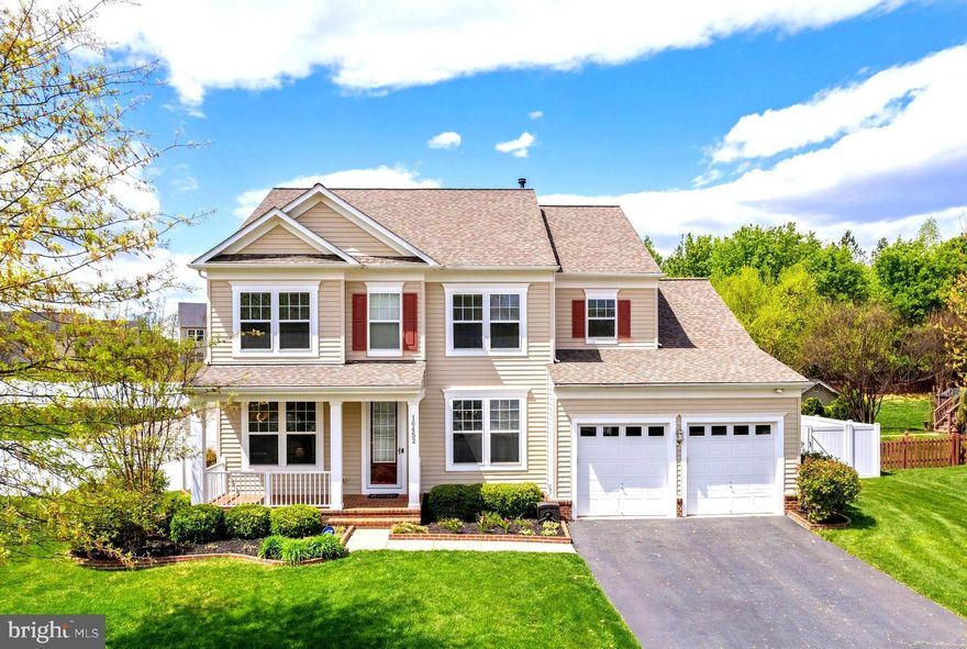 Welcome to 16452 Chattanooga Lane in the highly-regarded Powells Landing community. This elegant colonial-style single family residence spans over 4500 sqft on three finished levels.  Built in 2010 and immaculately maintained there is space here for any/all making it perfect for those seeking space, quiet, comfort, and upscale living. This house is light, bright, tastefully updated, and ready for a new family to call it home! The main level features a formal living room (easily used as study), and formal dining room to the right and left of the main entrance when stepping inside. The upgraded wood floors shine throughout the entrance and into the primary family space which is completed with windows (there are windows everywhere!) and a gas fireplace. Opposite the massive family room is one of the best-planned-kitchen spaces you will ever see! There is an eat-in space and just behind that is the kitchen island with breakfast bar. Beyond the island is the cooktop and microwave while to the left is more cabinets with large sink and views of the backyard and to the right is the fridge even more cabinets and a double oven! There is a service pantry on the left side with a walk-in pantry too, and on the right is a mudroom and access to the garage (don't miss the TALL garage doors). This is one of the most thoughtful kitchen layouts with space for everything, everyone, and counter and cabinet space galore! The upper level, the residence, includes three large guest rooms with LARGE closets, a full ball bathroom, and top-floor full size laundry machines in a laundry room! The primary bedroom is a jaw-dropper with a clever his/hers walk-in closet that provides both space for clothing and privacy. The primary bathroom has a double vanity setup including space for make-up /bench or laundry hamper and separate standing shower and soaking tub too! The lower level has a secondary family space, home gym/theater/study, mechanical room, full bathroom, and a bedroom/flex room  with yet another massive walk-in closet. The backyard is fully fenced-in with a privacy fence, matching storage shed, and gorgeous end to end paver patio! Outside there is a built-in awning that can be opened to keep things cool and fireplace to heat things up too! Professionally landscaped, just mulched, and in-ground sprinklers keep things looking tidy on the outside. Just bring your rocking chairs for the front porch and enjoy! Newer roof, HVAC, and water heater... this house has been meticulously maintained and truly needs nothing. Come and see this one in person!