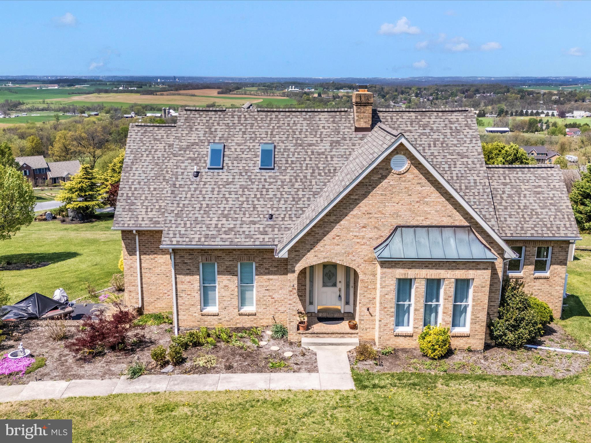 Welcome to this beautiful and bright home in the Orange Blossom Estates of Smithsburg, Maryland! This gorgeous all-brick 4-bedroom, 2.5-bathroom home is perched on nearly 1.5 acres atop a scenic hill, offering breathtaking panoramic views of the mountains and valleys, stretching across PA, VA, and WV. Step inside to find hardwood flooring throughout the first floor, where a warm and inviting living room boasts a brick chimney fireplace and cathedral ceilings. The formal dining room also features cathedral ceilings, adding to the home's spacious, open feel. The kitchen was updated in 2024 with brand new granite countertops and a large kitchen sink, and opens through double doors to a massive 16’x34’ elevated deck and gazebo (2024). The main-level primary suite includes a huge walk-in closet and a luxurious en suite bathroom with a jacuzzi tub and updated standing shower. Upstairs, you'll find a large full bathroom with two newly installed skylights (2024), a second bedroom with a walk-in closet and extra storage closet, and a third bedroom featuring a sitting area. Downstairs, the walkout basement offers flexibility with an entertainment area and an additional room that can serve as a fourth bedroom. One room has partially installed flooring, and the rest is ready for your finishing touch. Over $80,000 in thoughtful renovations have been made in the past five years. Additional features include new wind-resistant roofing (2024), replaced vents (2024), a new water tank (2023), a newly paved 150-ft driveway that can fit up to 12 cars (2023), a new water filtration system (2022), water-proofed basement (2020), an added 14’x20’ shed (2020) conveniently located near the deck, new washer and dryer (2020), new HVAC system (2019), a beautiful gardening space, and an oversized 2-car attached garage with direct basement access. Location is key! This home is just minutes from Routes 70 and 81 for easy commuting and is close to Hagerstown, Frederick, and Harpers Ferry. Families will love being part of a community served by National Blue Ribbon-recognized elementary, middle, and high schools! AS IS SALE!
