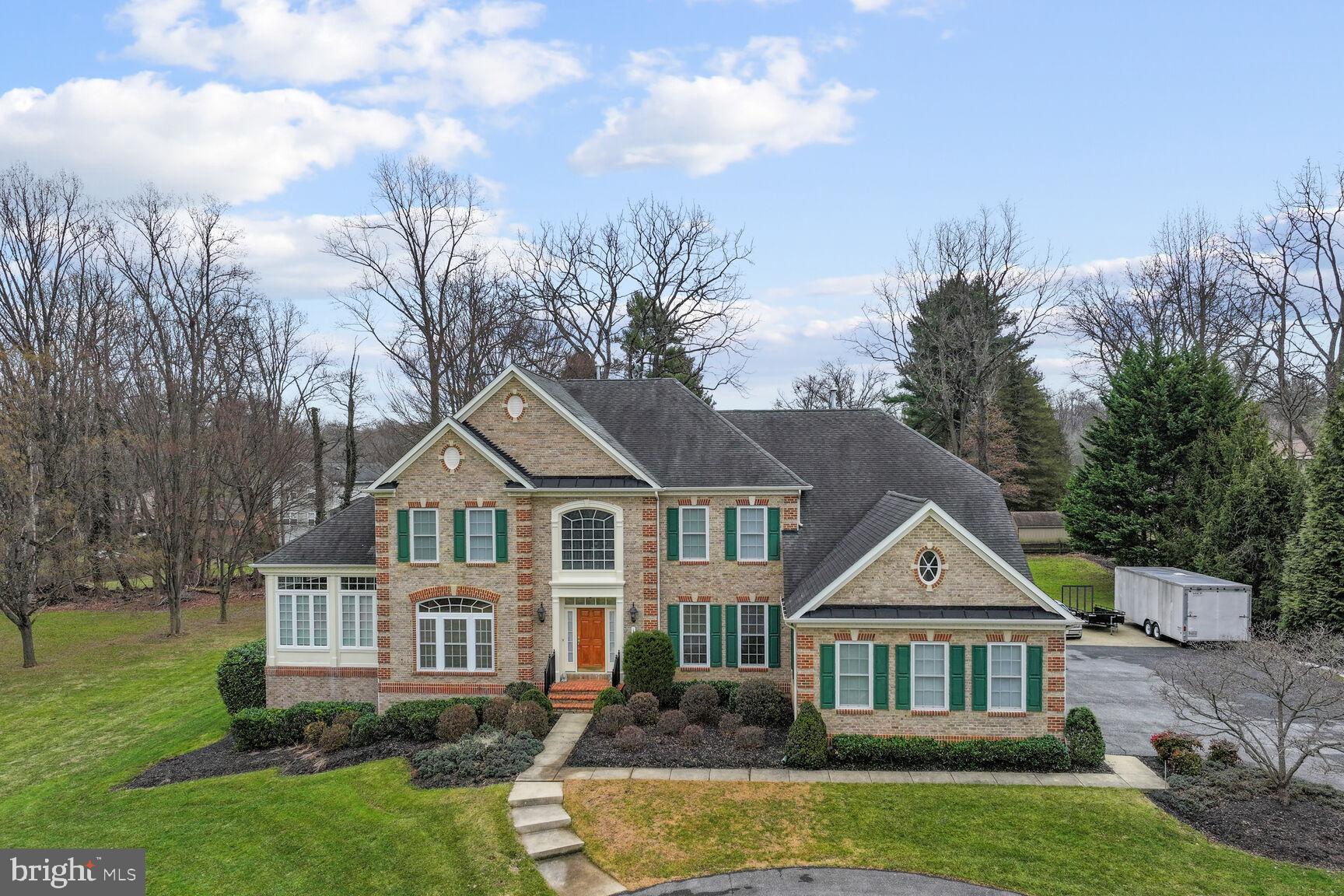 No, Home Owners Association ( HOA ) !!! Exuding effortless style and character, this remarkable 4-bedroom, 4.5-bath Ashton estate is one you’ll be proud to call your own! Set well back from the street, this 3-level Colonial stunner, with an impressive 4,544 sq ft above ground, stands on 3.6 acres of lush natural beauty. A long driveway bordered by mature trees leads to this incredible gem’s picture-perfect brick facade. Enter a bright, welcoming foyer where an elegant chandelier suspended from soaring ceilings illuminates the grand winding staircase. Stately columns and gorgeous Brazilian Cherry hardwood flooring cascade across the main gathering areas, which include a formal living room which leads to a tropical sunroom, formal dining room, guest powder room, and step-down family room warmed by an inviting stacked-stone fireplace equipped with a multi-room sound system
Show off your culinary skills in the open gourmet kitchen, sporting a suite of top-notch stainless steel appliances, including both gas and electric ovens, abundant cabinetry, a spacious pantry, and dark granite countertops extending to the island and breakfast bar. A few steps away, enter a cozy keeping room and breakfast area surrounded by windows with tranquil views of the meticulously maintained grounds and entry to the composite deck. The back stairway leads you upstairs, where you can retire to the comfortable proportions of the carpeted private retreats, which include a 2nd bedroom with a private bathroom and large closet as well as a 3rd and 4th bedroom joined by a buddy bathroom. Surpassing them all, the magnificent primary suite boasts a luxe ensuite with 2 walk-in closets, a laundry chute, a separate shower, and a spa soaking tub nestled by the window. Another full bath enhances the finished 2,504 sq ft walkout basement.
When you need a breath of fresh air, this home offers an idyllic outdoor oasis where you can unwind in peace. Host weekend BBQs on the deck, share nightcaps around the fire pit, relax in a hot tub surrounded by a brick privacy wall, or celebrate memorable occasions in the expansive backyard. Additionally, there is a gasoline backup generator, 2 large outbuildings that measure 12X28 and 14X36, natural gas heating, a central vac, and an attached side-load 3-car garage. Come for a tour before this hidden treasure passes you by!
