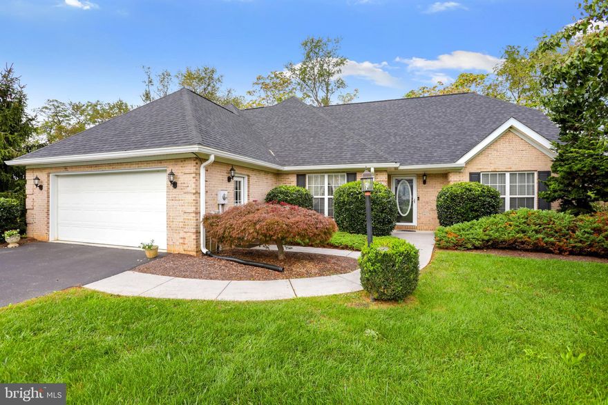 Beautiful Brick Front Home located in sought after Locust Hill Subdivision. This property features 2400 Sq Ft of finished living space on 2 levels including 3 Bedrooms and 2.5 Baths. Main level features a light filled open layout perfect for entertaining with vaulted ceilings! Gourmet Kitchen has upgraded counter tops, hardwood flooring, built in microwave, gas stove, and space for a dining table.  Formal Dining Room with hardwood. The Family Room and Living Room share a 2 sided gas fireplace. Main level Primary Owner's Suite with tray ceilings, built-in closet, and attached luxury bath with jetted soaking tub and separate shower. Upper level includes two large Junior Bedrooms with a shared Bath. The 3rd bedroom has an extended bonus room for storage or could be used as a playroom, office, man cave, craft room and more! 2 car attached garage and drive offers plenty of parking. Mature landscape with fenced rear yard backing a quiet peaceful country setting. Relax on the spacious deck or screened porch! Locust Hill is a golf course community and golf memberships are available.