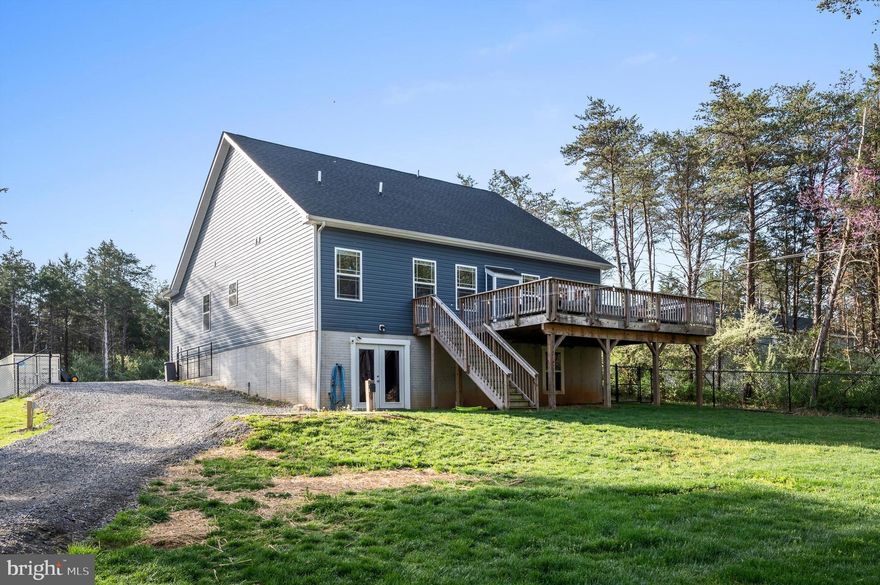 Live every day like you won the lottery. Priced $25K under appraisal, this rock-solid, 3-bedroom, 2-bath waterfront rancher on the Opequon Creek is 15 minutes from Hwy 7, making for an easy commute across northern Virginia, but in a completely secluded and quiet little neighborhood. Out of the flood zone, with no HOA and no restrictions, this is truly a unicorn. Fish, kayak, or chill by the water’s edge, then soak in sunsets from the vaulted great room, huge entertainer’s deck, or even the primary bedroom. Love to cook? The chef’s kitchen features an expansive marble-topped island and a luxurious walk-in pantry. Modern must-haves include a full-home propane generator, EV charger, oversized double garage, and RV pad with hookups. The walkout basement already has LVP flooring and a bath rough-in, giving you the chance to double the floorspace with ease. The fenced yard, wooded firepit area, and the option to keep furnishings and the business, makes this home both freedom and lifestyle. Pictures cannot do it justice, come see it with your own eyes and bring your imagination!