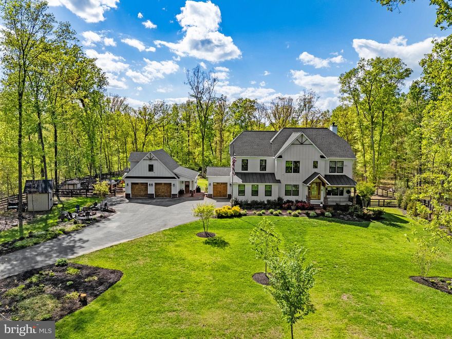 **Welcome to this stunning, nearly-new craftsman-style home nestled in the sought-after Buckland Woods area on 5 park like acres. Built in 2020, this beautifully appointed 7-bedroom, 6-bathroom residence spans over 6,000 square feet of thoughtfully designed living space — offering the perfect blend of modern elegance and everyday comfort.  Step inside to find custom features, sun-drenched interiors, and premium finishes throughout. The open-concept main level flows effortlessly from a chef's kitchen — complete with quartz countertops, stainless steel appliances, and a generous island — into a spacious great room ideal for entertaining.  A dedicated office nook, mud room with built in lockers & walk-in pantry are just a few of the  "extras" that make this home not only beautiful, but functional too!!  A main level en-suite bedroom is tucked away and perfect for guests.  Just off the dining area, you'll find a screened-in porch to take in the views.   Upstairs, retreat to a luxurious primary suite featuring a spa-inspired en-suite bath, walk-in closets & sitting area, accompanied by well-sized secondary bedrooms and additional full baths & laundry.  The finished lower level provides flexible space with rec room including wet bar, a media room, gym/bedroom & full bath.  Windows and doors let in ample natural light and allow easy access to patio & fenced yard.   With a 3 car attached garage, oversized detached garage/workshop with additional space above (could be easily finished), there is no shortage of storage or hobby space.  For hobby farmers, the chickens even have luxury accomodations and be sure to take advantage of the greenhouse.  Enjoy the tranquility of this peaceful, picturesque neighborhood surrounded by mature trees and the natural beauty of Western Prince William County. Located within walking distance to Lake Manassas, an easy drive to boutiques and dining of Haymarket, Gateway Shopping, Route 66, and Route 29.  This is Northern Virginia living at its finest — where privacy, style, and location converge. Don't miss your opportunity to call this exceptional property home.