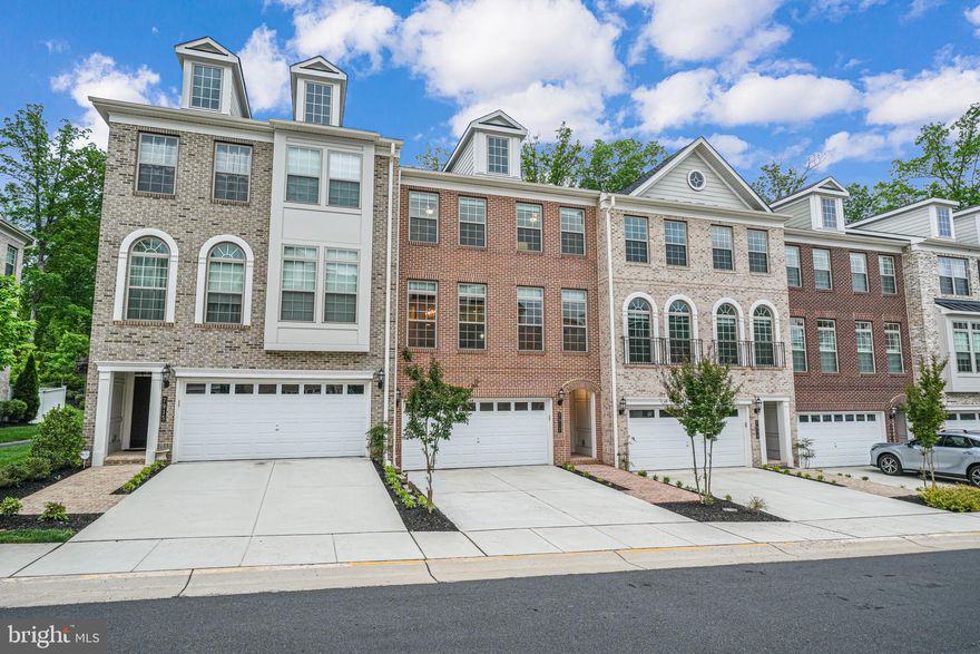 Welcome home to this better than new luxury townhome in the prestigious gated golf community of Lake Manassas. This 4 bedroom, 4.5 bathroom townhouse is on one of the most desirable lots in the neighborhood, backing to trees, providing privacy to enjoy your back patio, two balconies, and fenced in yard. The lower level features a 4th bedroom and a full bathroom. The main level has the kitchen, butler's pantry, dining room, living room, and family room. The top level has three bedrooms that each have their own separate bathroom. No upgrade has been spared: a luxury kitchen with upgraded cabinets, oversized island, quartz countertops, backsplash, and waterfall, 36” gas wolf range, cafe refrigerator with built in keurig, wall oven, farmhouse sink, and reverse osmosis water filter; bathrooms with upgraded tile, vanities, quartz countertops, and fixtures; a master bathroom that features a soaking tub, and a rain shower; custom closet organizers in both the his and hers closets; whole house water softener and carbon water filter; luxury laminate flooring throughout all 3 levels; wood beams, built-ins, and gas fireplace in the living room; custom blinds throughout, and a natural gas grill hookup. Lake Manassas is truly a one-of-a-kind community offering a host of amenities, including a 24/7 manned entrance gate, swimming pool, lighted tennis, pickleball, and basketball courts, and miles of walking trails. There are also 2 of the top golf courses in the area located in the community.  Walkable to shopping and dining.  You do not want to miss this one!