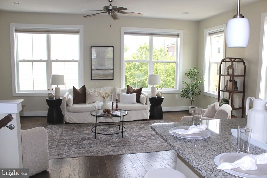 Stylish, Sophisticated & Lightly Lived In! This home offers ideal Suburban charm with all the Urban conveniences. Welcome to this beautifully maintained 6-year-old townhome located in a highly desirable community boasting excellent walkability & just minutes from the metro & a variety of dining, shopping, & entertainment venues.  Whether you're entertaining in the bright, open living spaces or relaxing in one of the comfortable bedrooms or roof deck, this home offers comfort & flexibility for any lifestyle. The versatile floor plan showcases 4 generously sized bedrooms, 4.5 baths,  fresh paint throughout & new carpeting making it move-in ready.  Enjoy modern amenities, a stylish open-concept layout, & the convenience of a 2-car garage.  The inviting entrance offers a main level bedroom and/or office space with attached full bath.  As you make your way to the upper level you'll find beautiful open space with tons of natural light. A large family room, an adjacent gourmet kitchen  & breakfast area are the heart of the home & showcase modern amenities from decorative light fixtures & stylish cabinetry to upscale finishes with  granite counters & stainless appliances.  A convenient half bath completes this level. Two generously sized bedrooms with en suite along with full laundry  & a storage closet are housed on the third level. The primary suite is tucked away on the top level offering privacy & a great place to unwind in the evening. The large bedroom with two walk in closets offers opportunity for various furniture configuration. The upscale bath offers two vanities & a spacious shower with bench.  A large top level deck is ideal for soaking up the sun or relaxing after a long day.